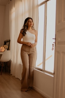 A woman standing in front of a window