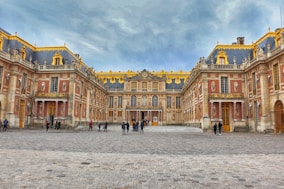 A large building with a lot of people walking around it