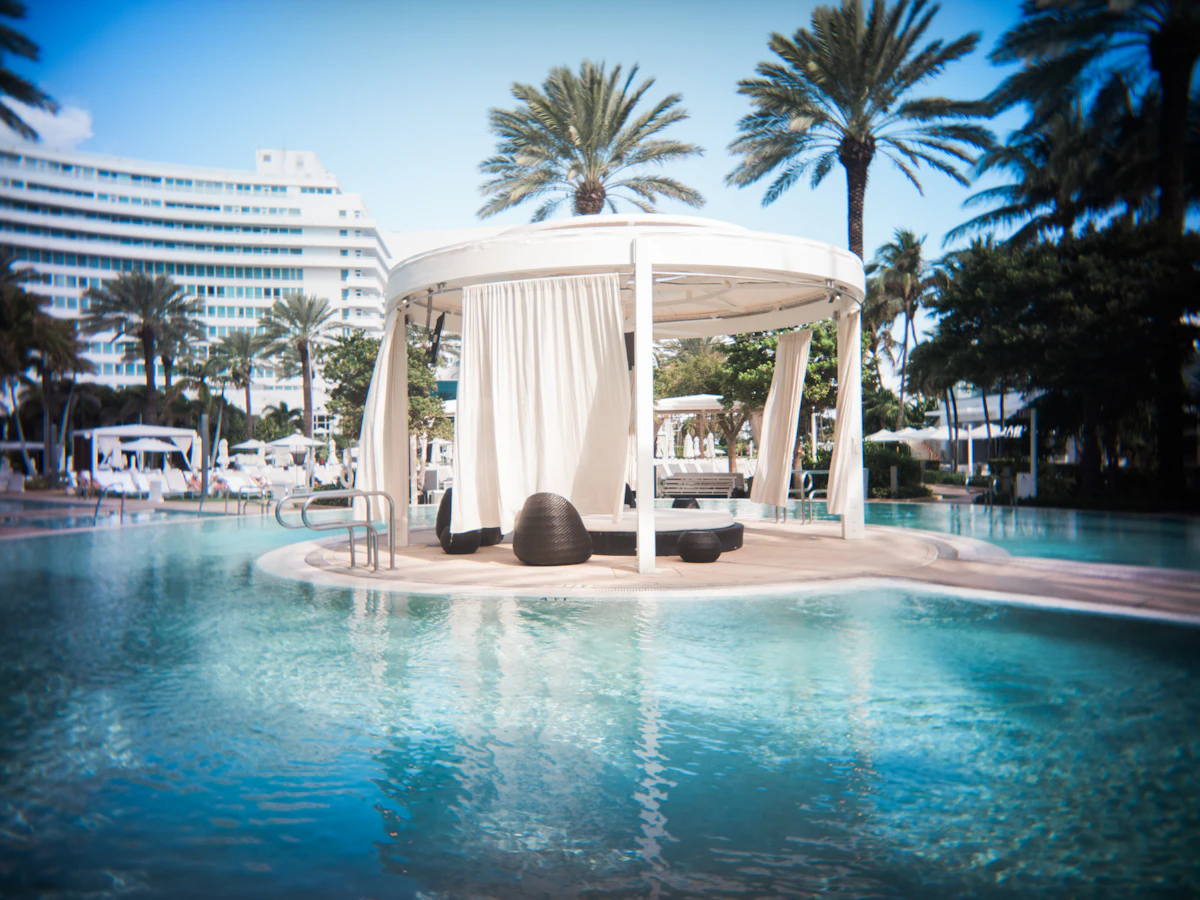 A pool with a gazebo in the middle of it