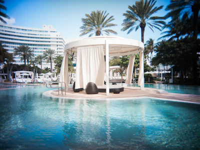A pool with a gazebo in the middle of it