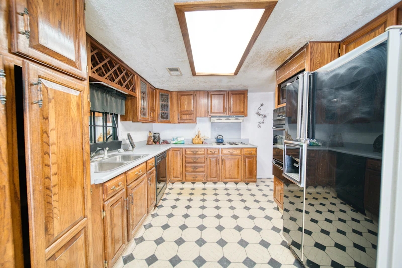 Dated oak kitchen cabinets before refinishing