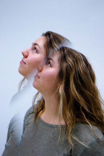 A woman looking up at something in the air