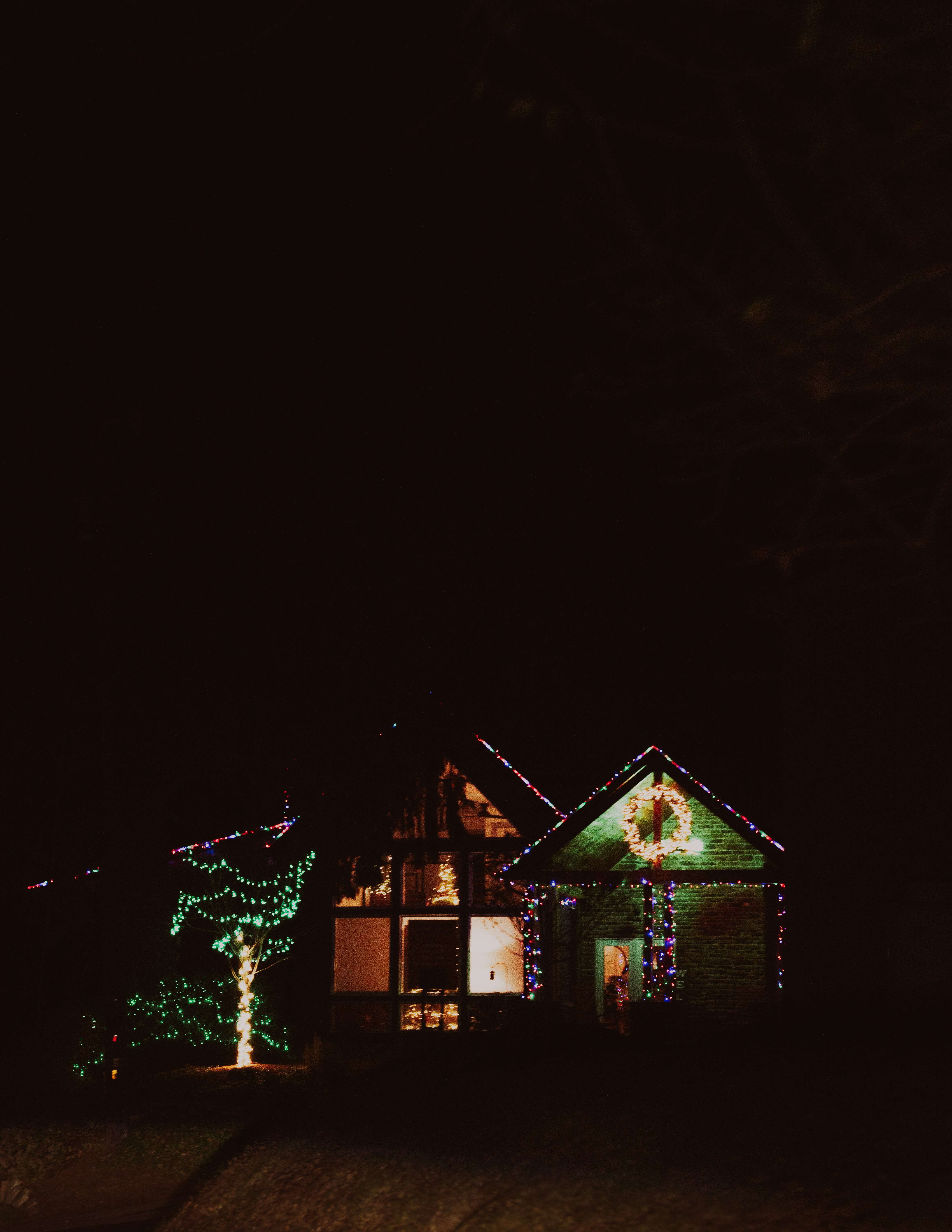 A house covered in christmas lights at night