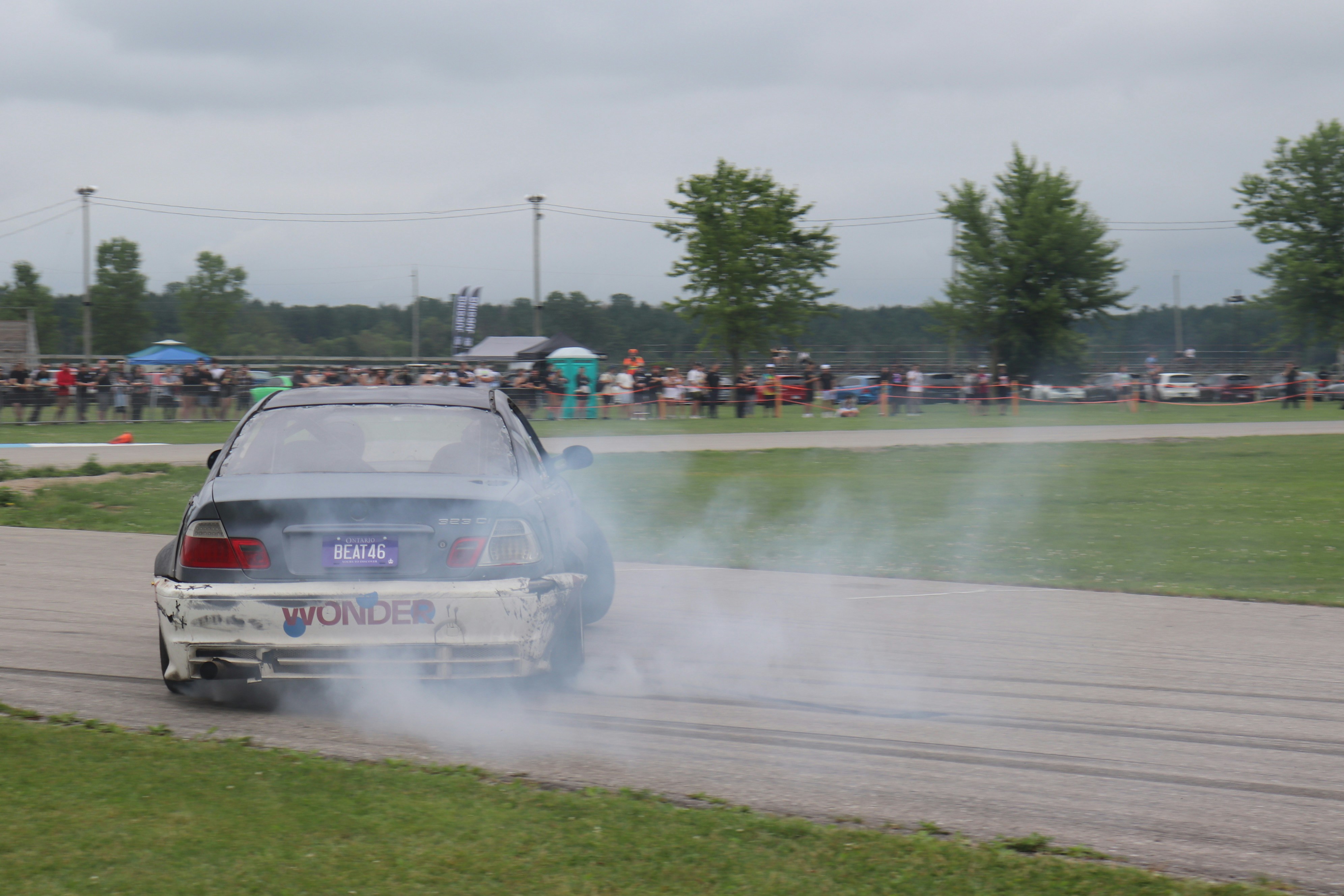 A car driving down a track with smoke coming out of it photo – Free ...