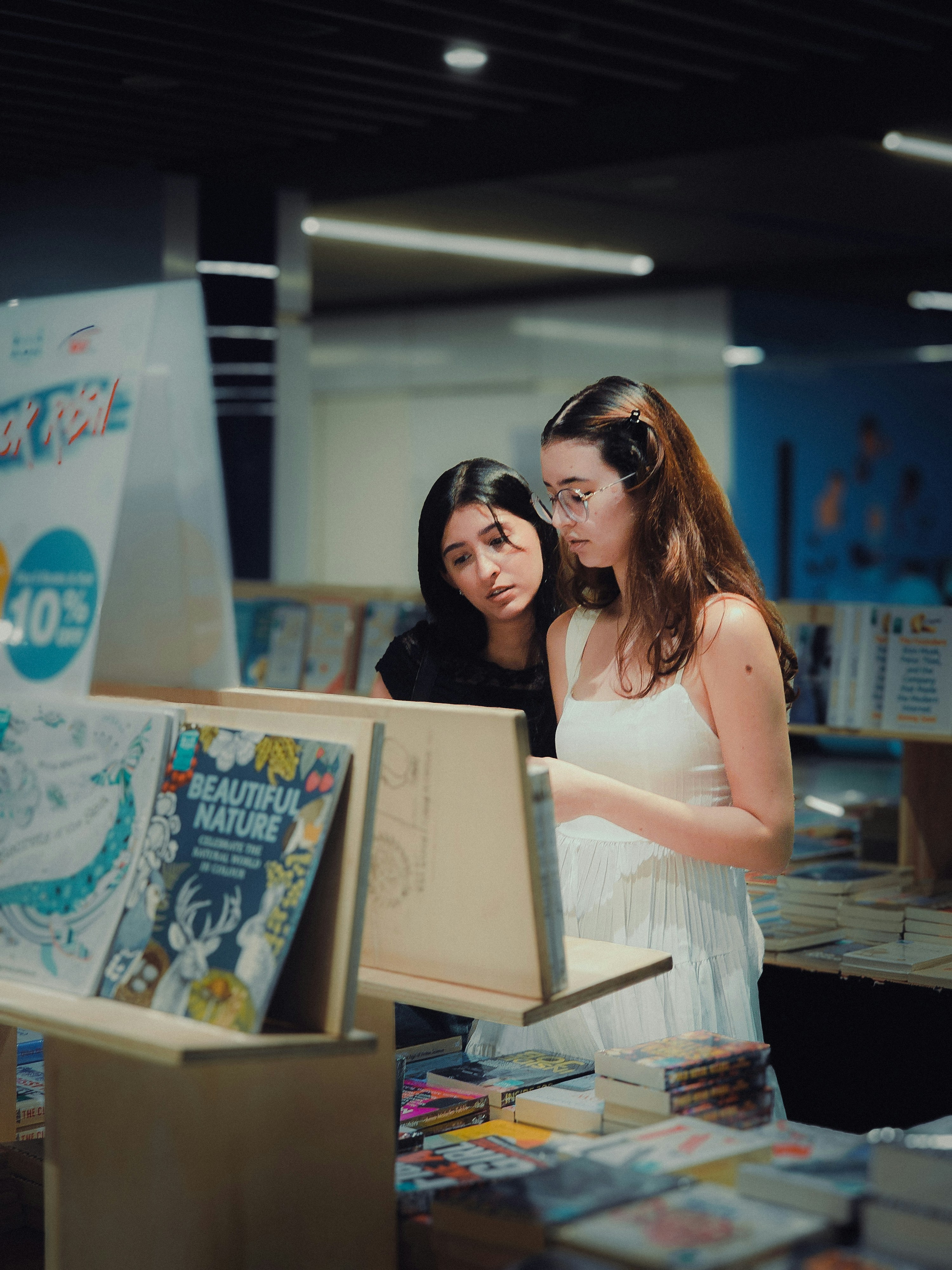 A couple of women standing next to each other in a room