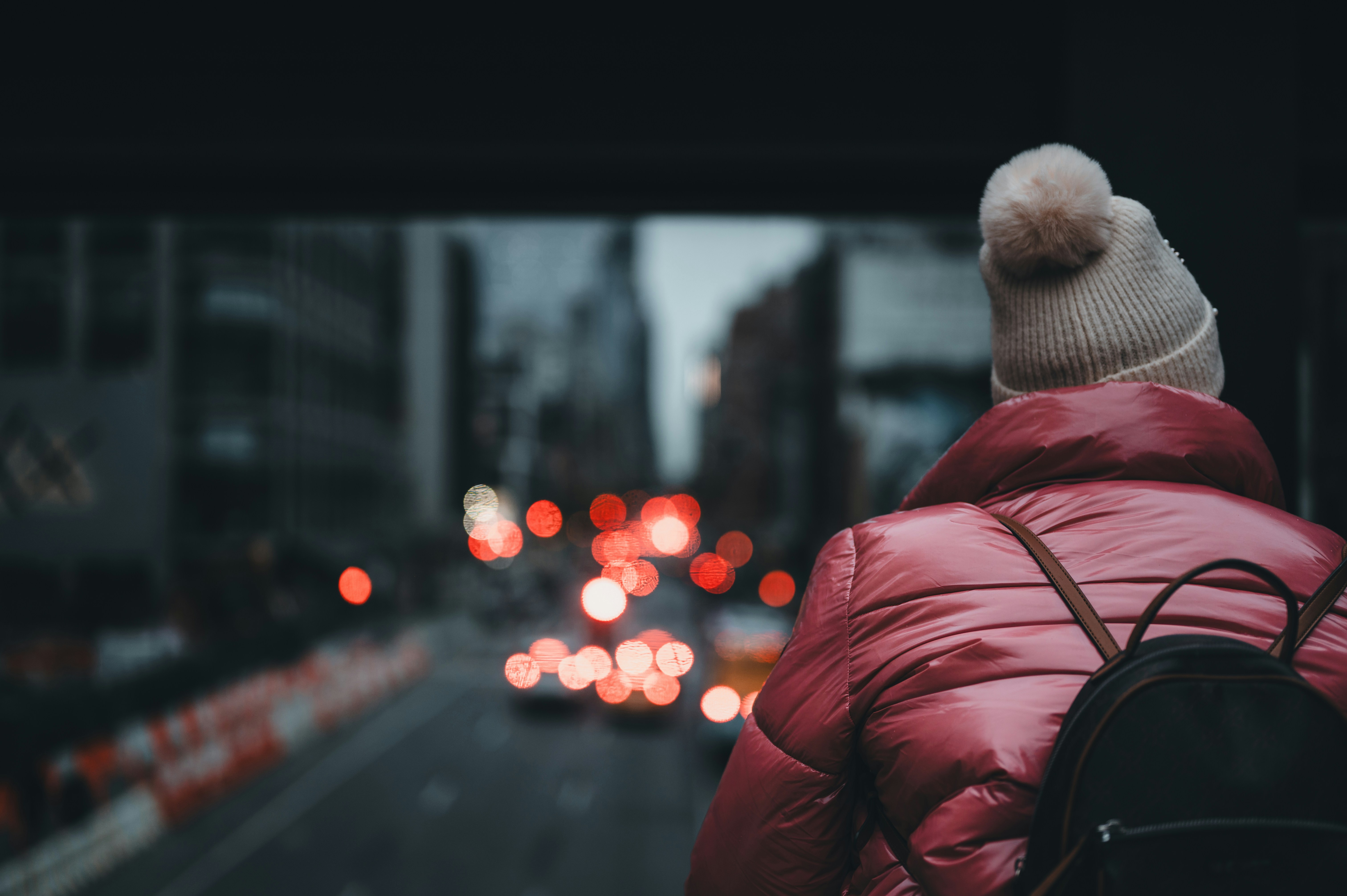 A person wearing a red jacket and a white hat