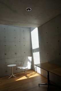 A room with a chair and a table in it