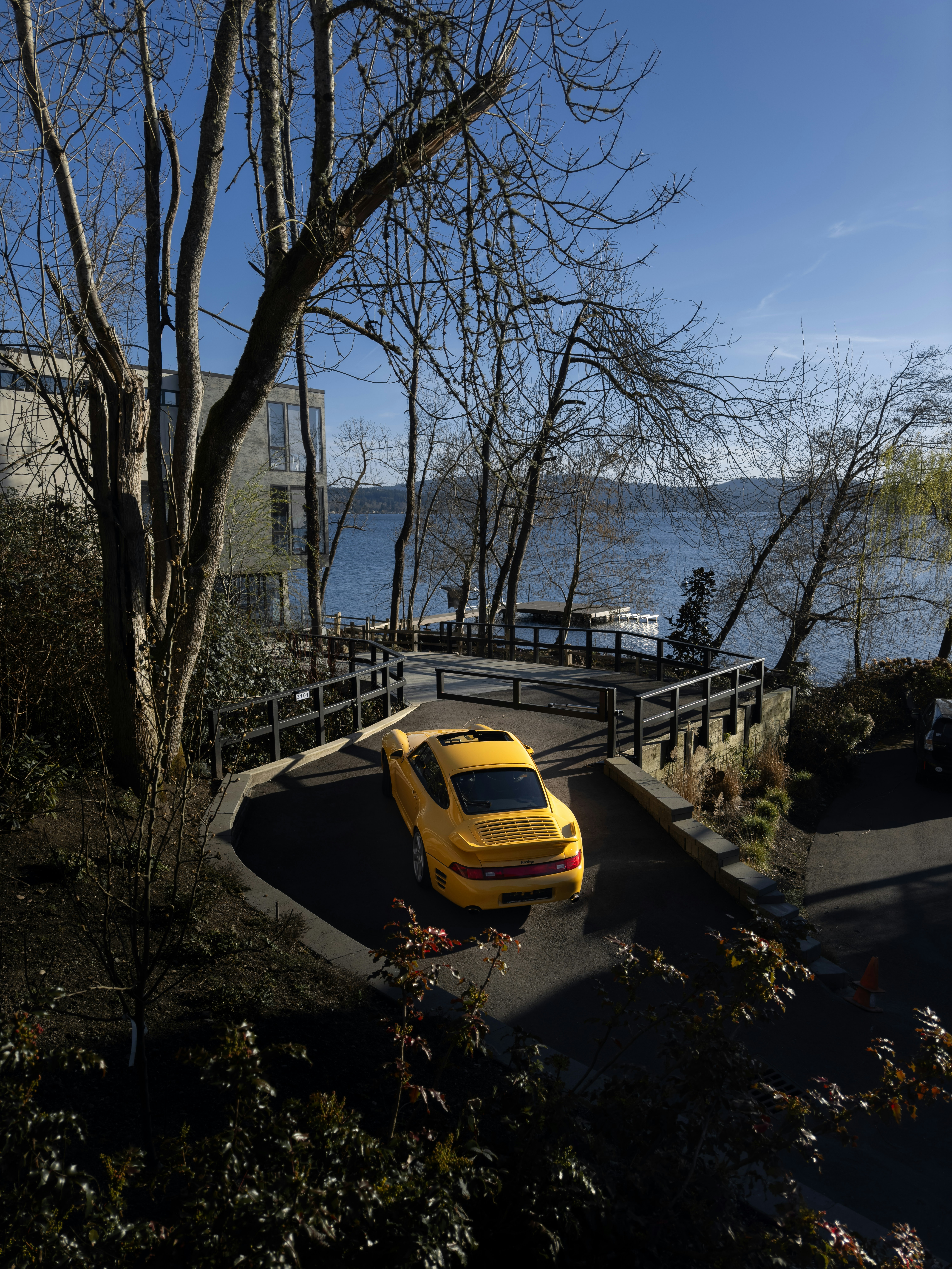 A yellow car parked on the side of a road