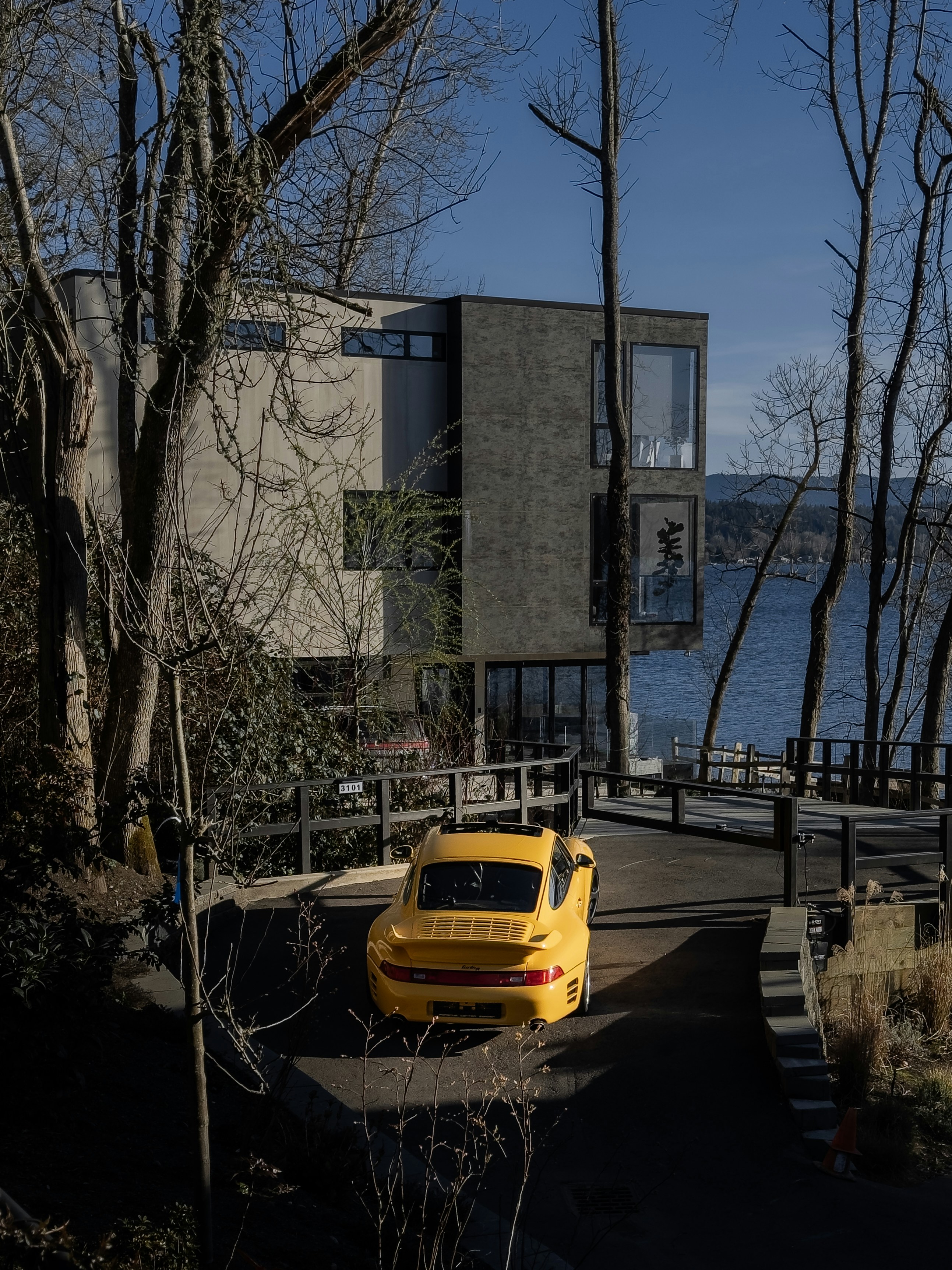 A yellow car parked in front of a building