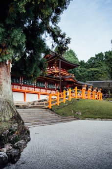 A building with orange railings next to a tree