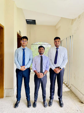 A group of three men standing next to each other