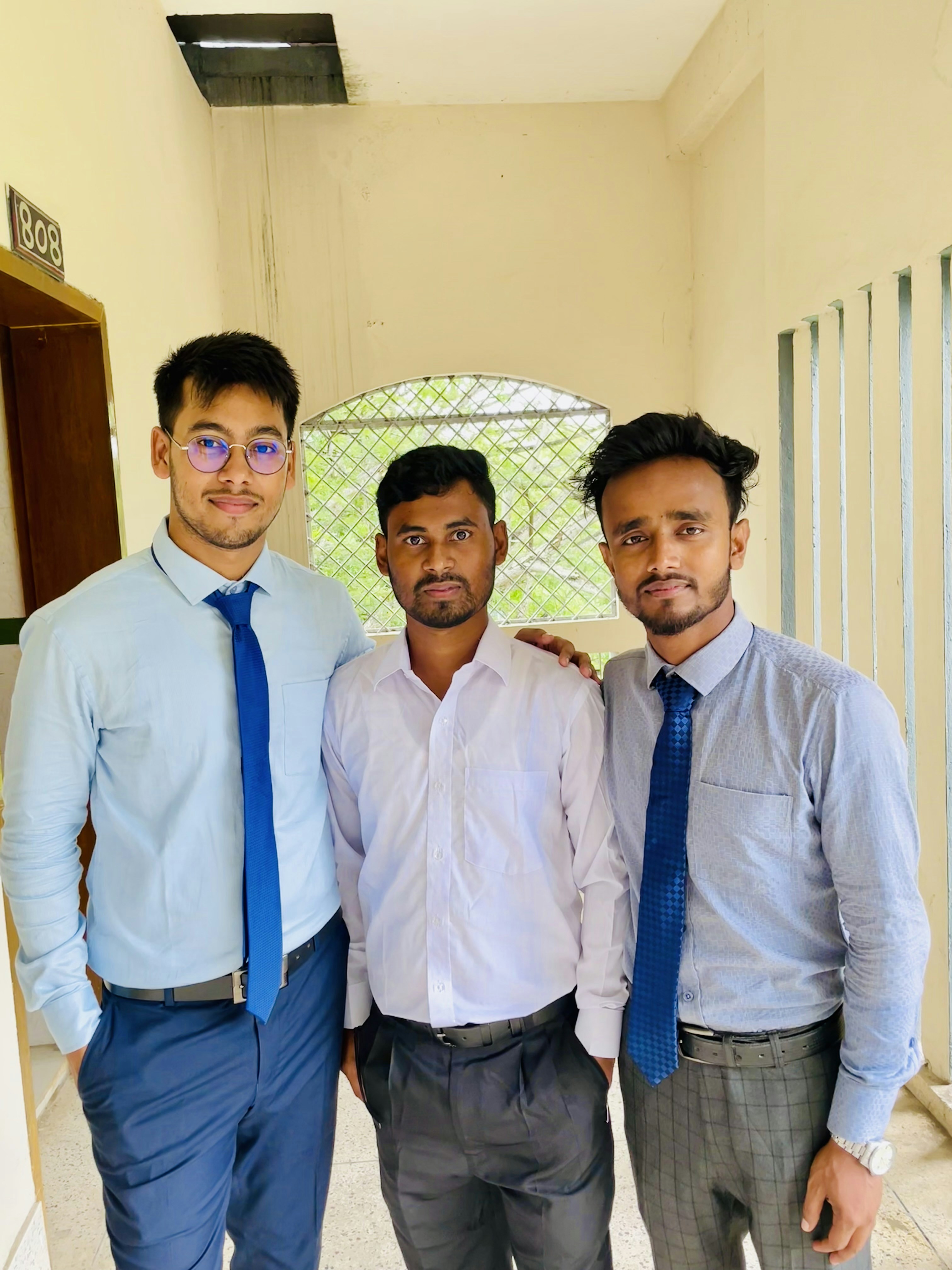 A group of three men standing next to each other