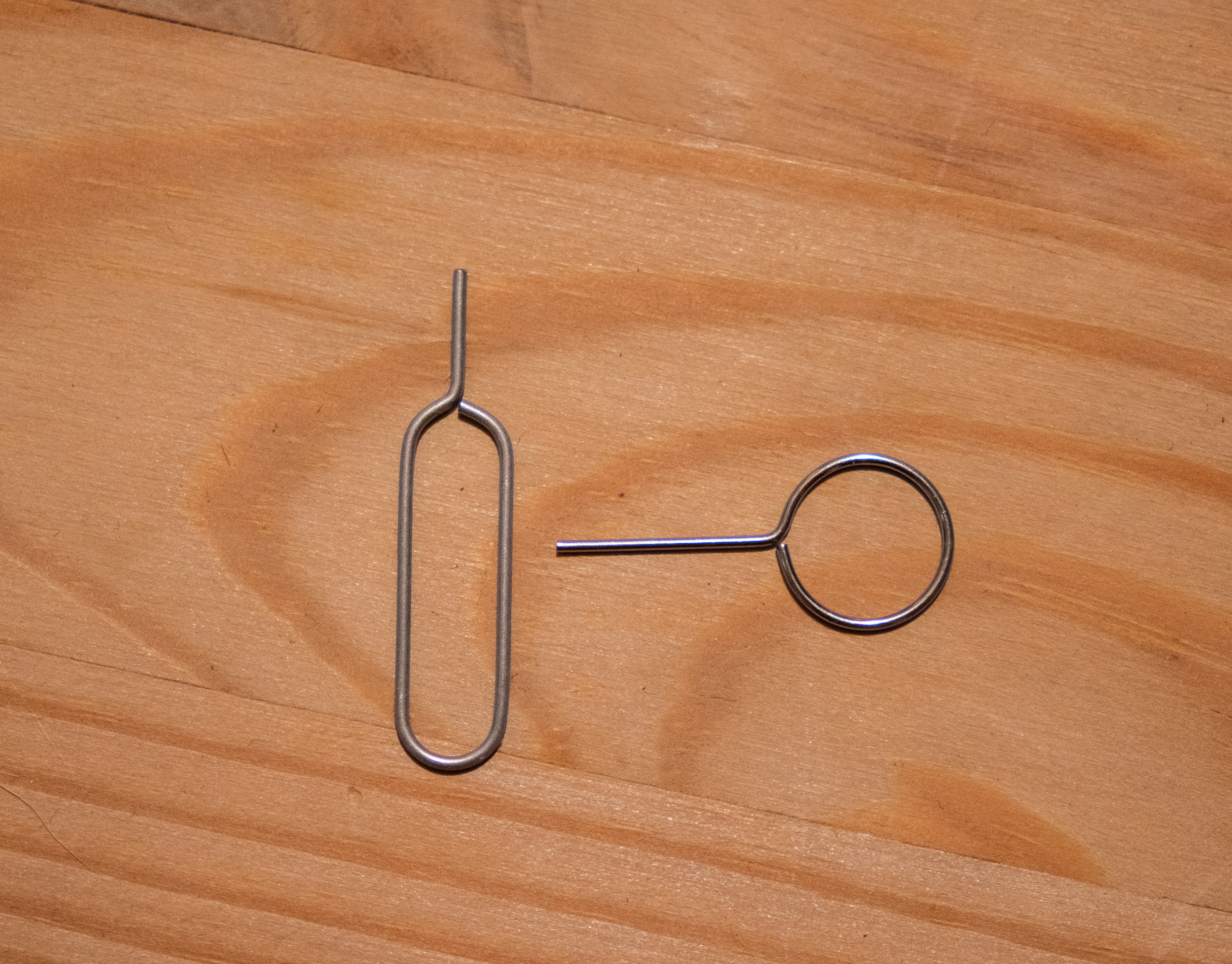 A pair of scissors sitting on top of a wooden table