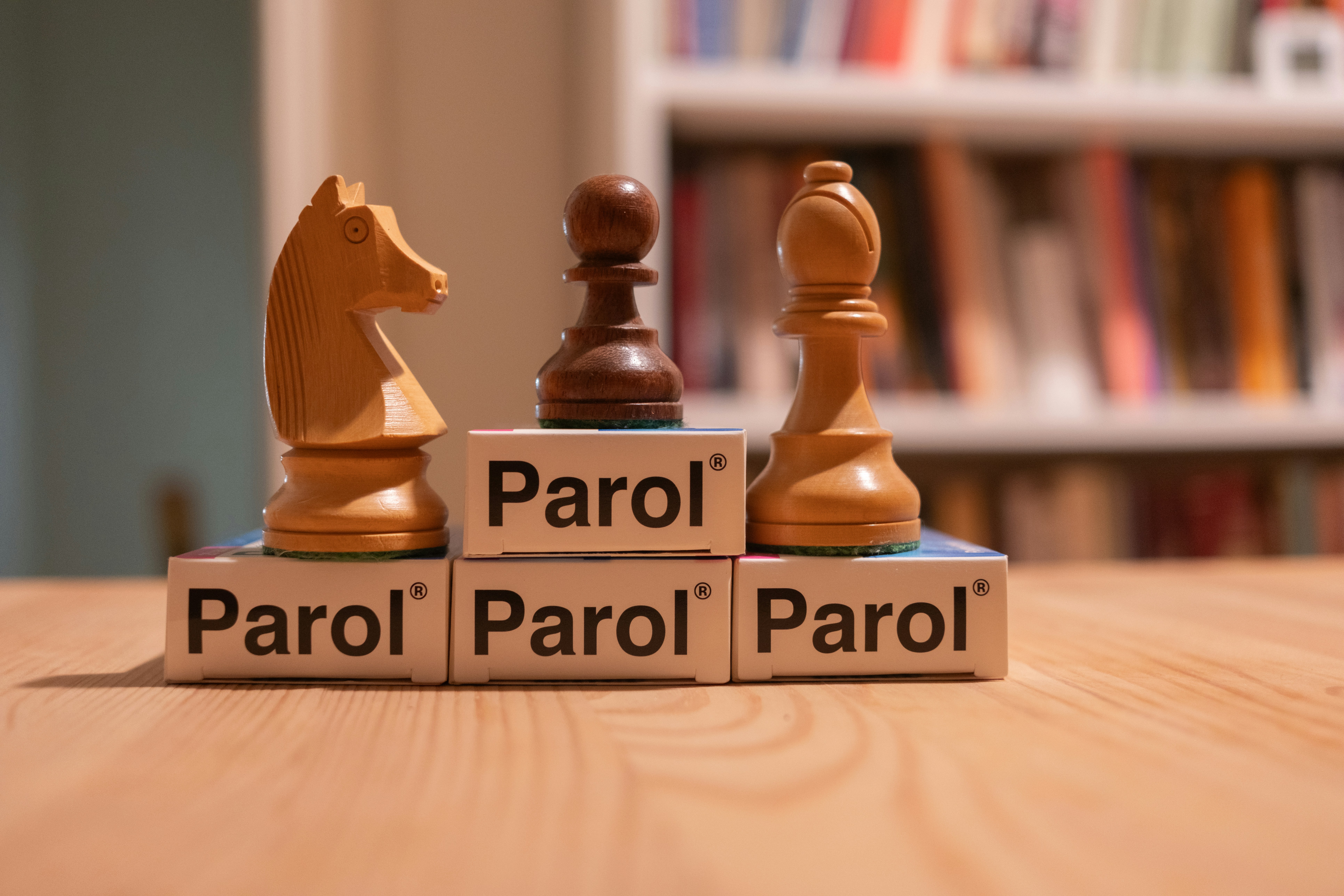 A couple of wooden chess pieces sitting on top of a wooden table
