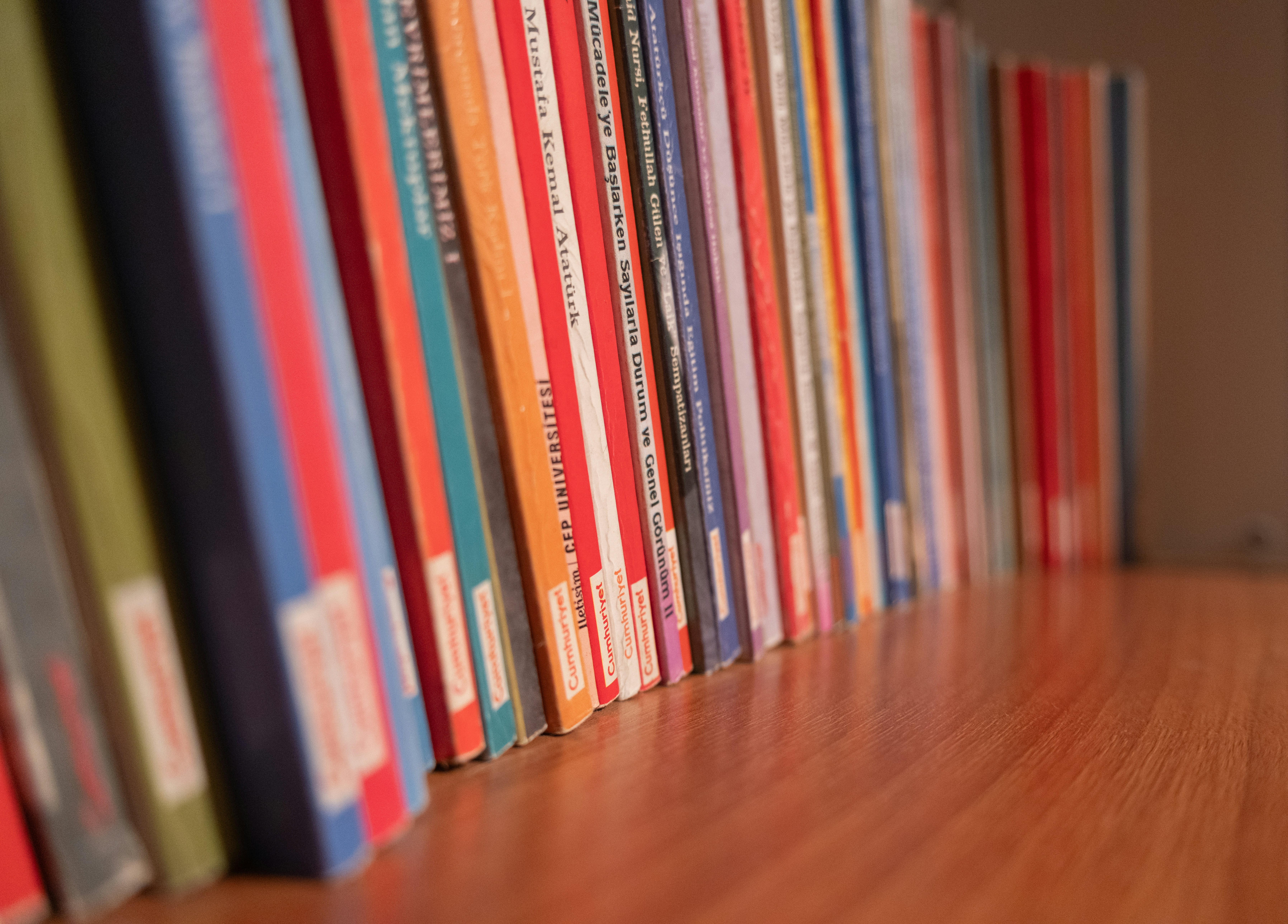 A row of books sitting on top of a wooden floor