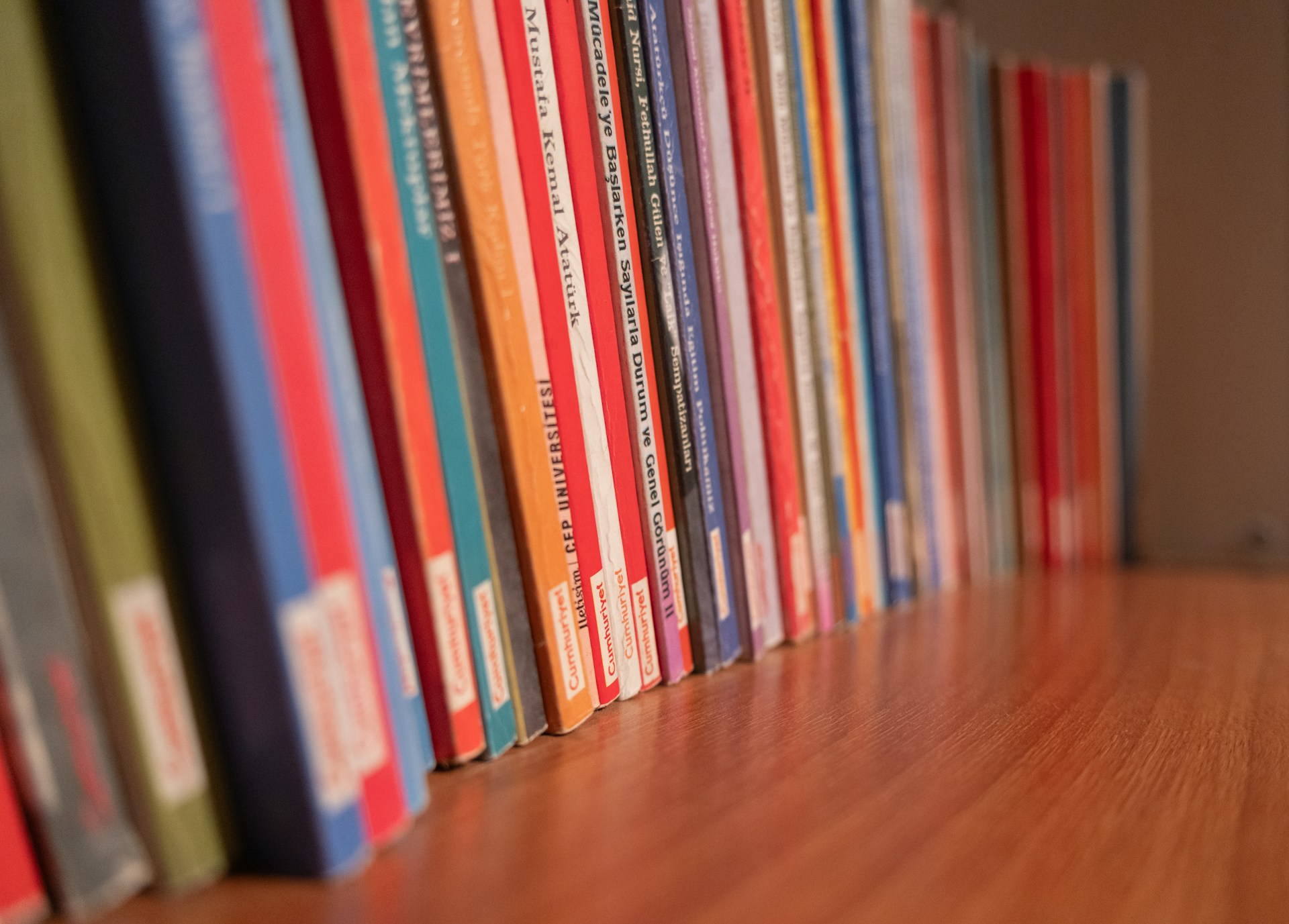 A row of books sitting on top of a wooden floor