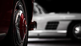 Two cars parked next to each other in a parking lot