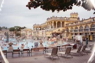 A group of people sitting around a swimming pool