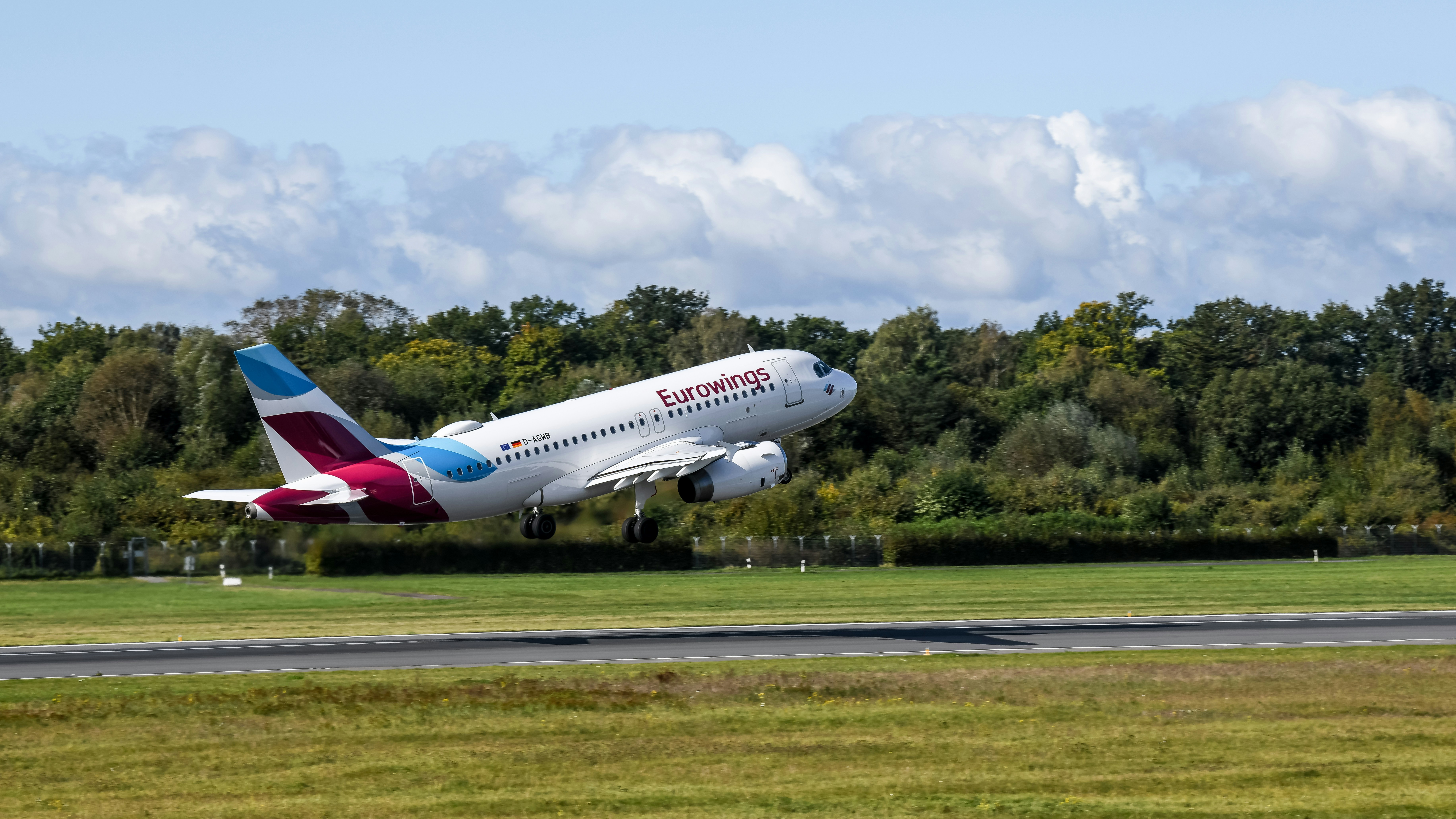 A large jetliner taking off from an airport runway