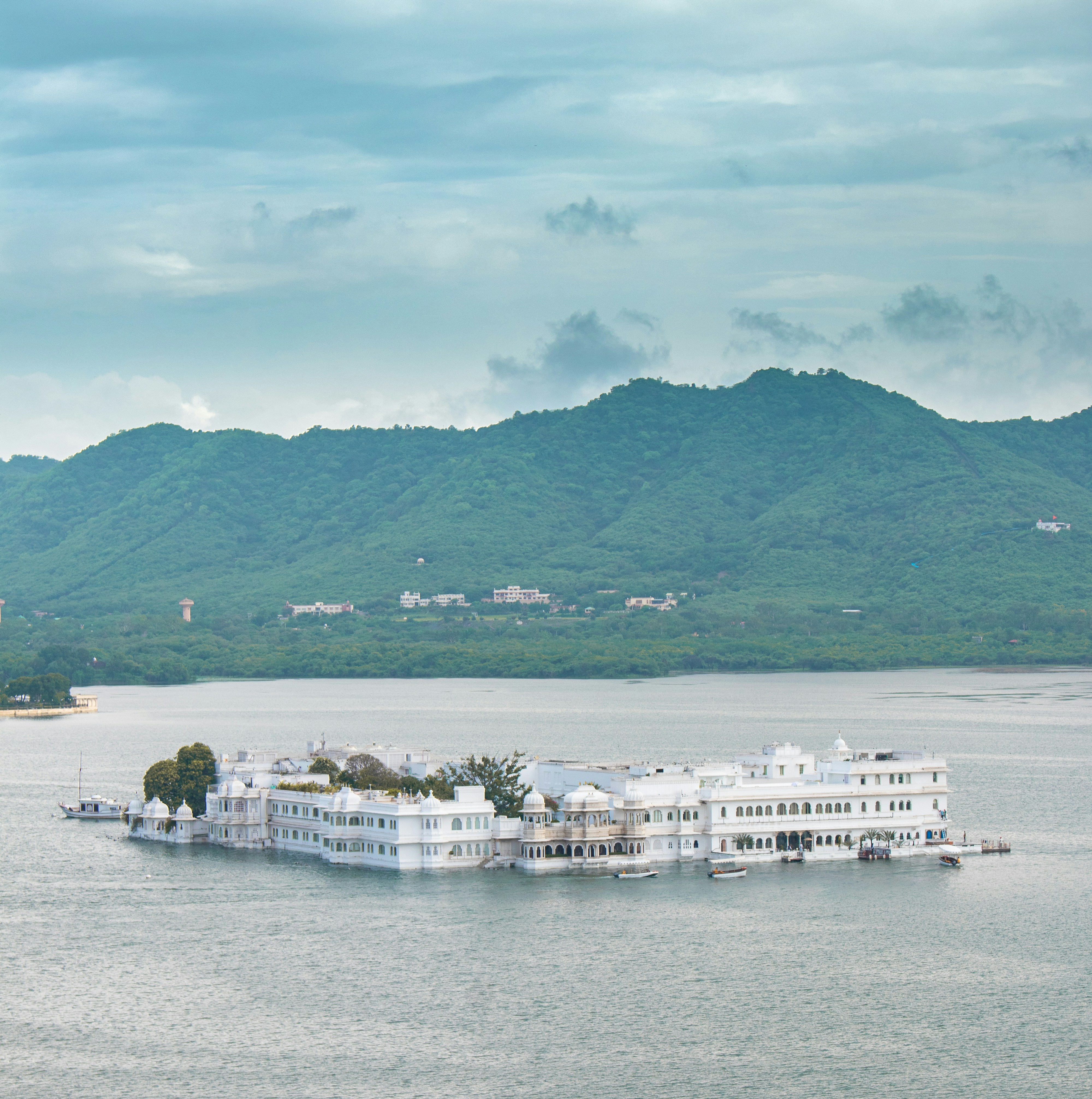 A large white building sitting on top of a large body of water