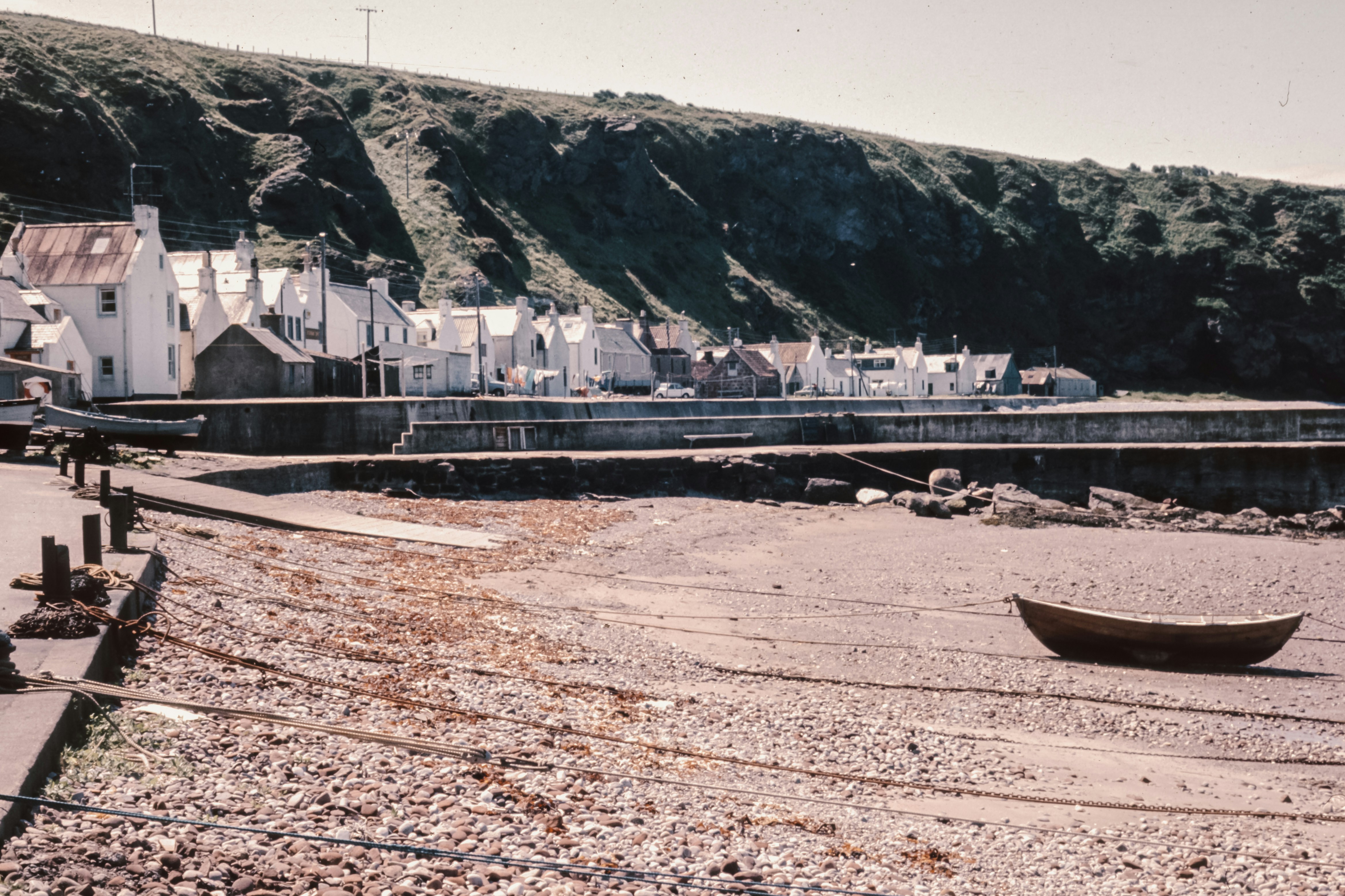 A boat sitting on top of a sandy beach