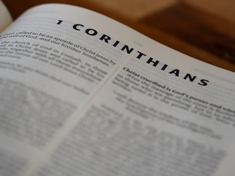 A close up of an open book with the word corinhans on it