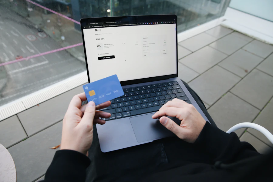 Person paying on a laptop with a credit card
