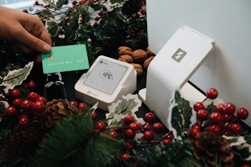 A person putting a card into a christmas tree