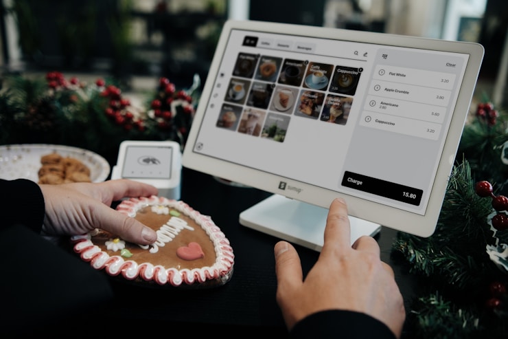 A holiday-themed setup showing a SumUp point of sale system, a decorated gingerbread cookie, and Christmas decorations, creating a festive retail environment.
