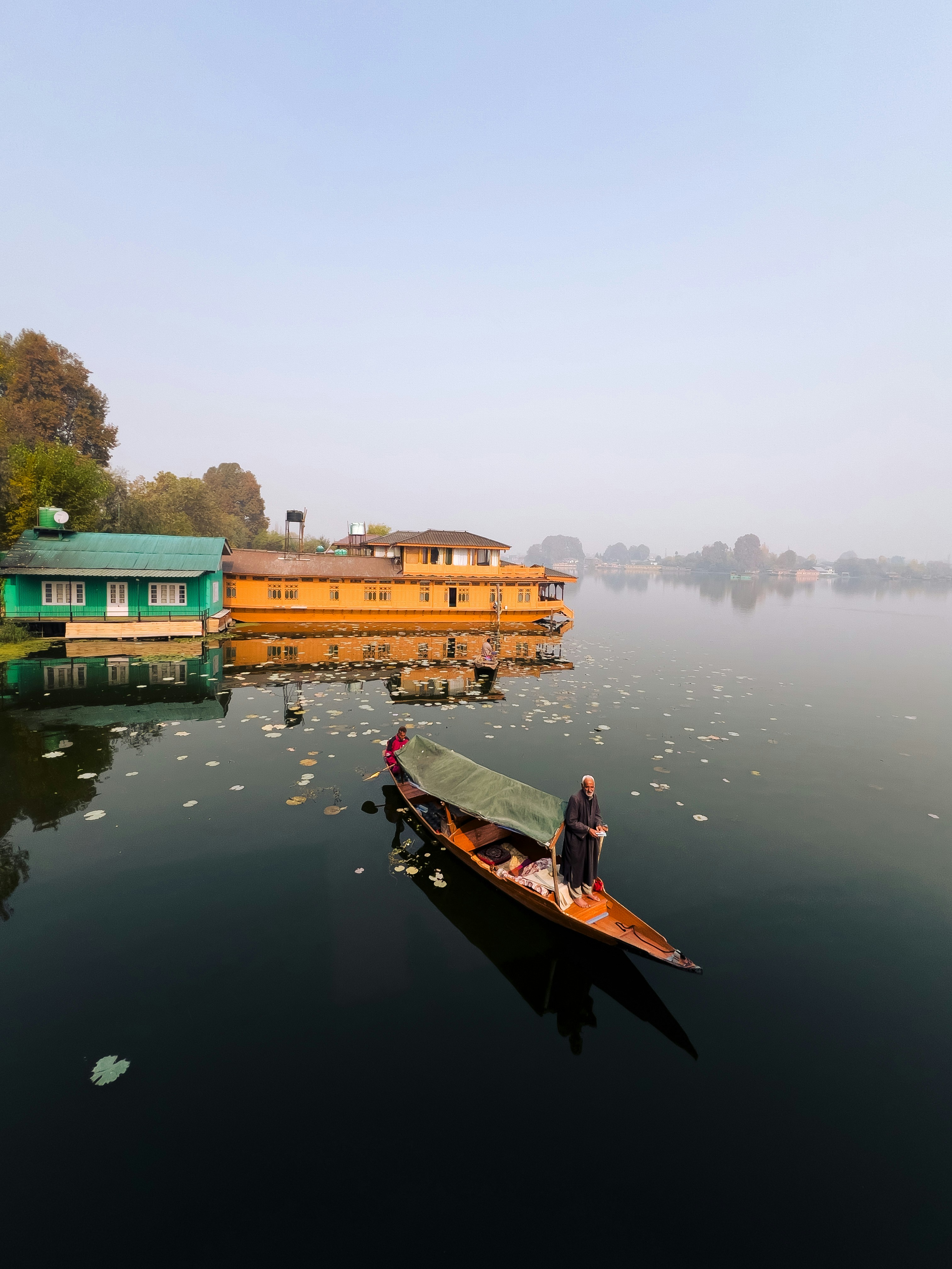 A person in a small boat on a body of water photo – Free Human Image on ...