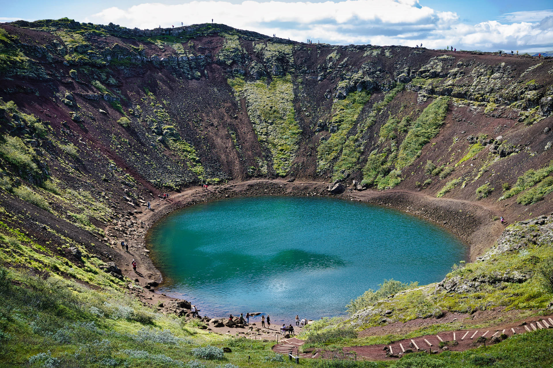 A large crater with a lake in the middle of it
