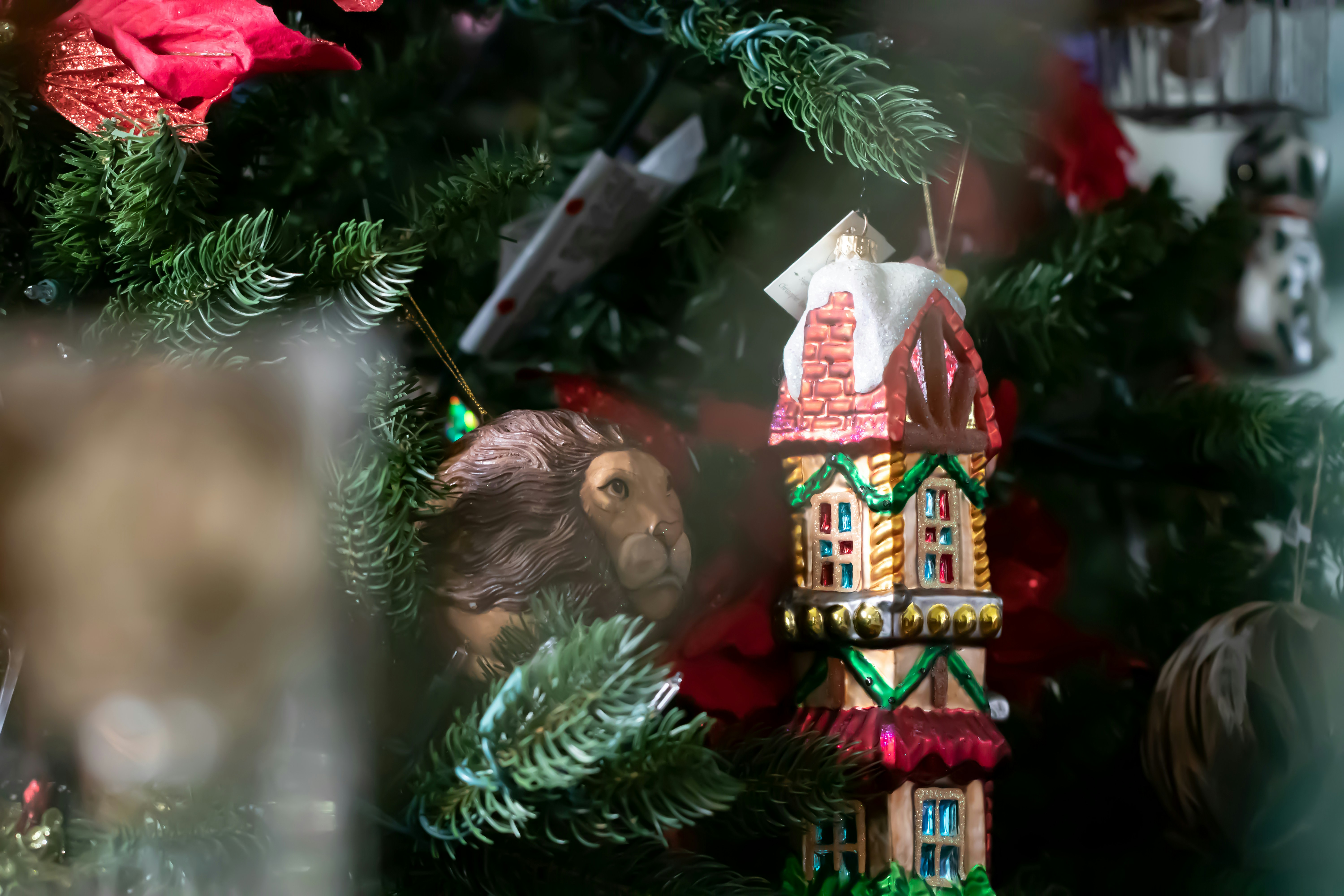 A close up of a clock on a christmas tree