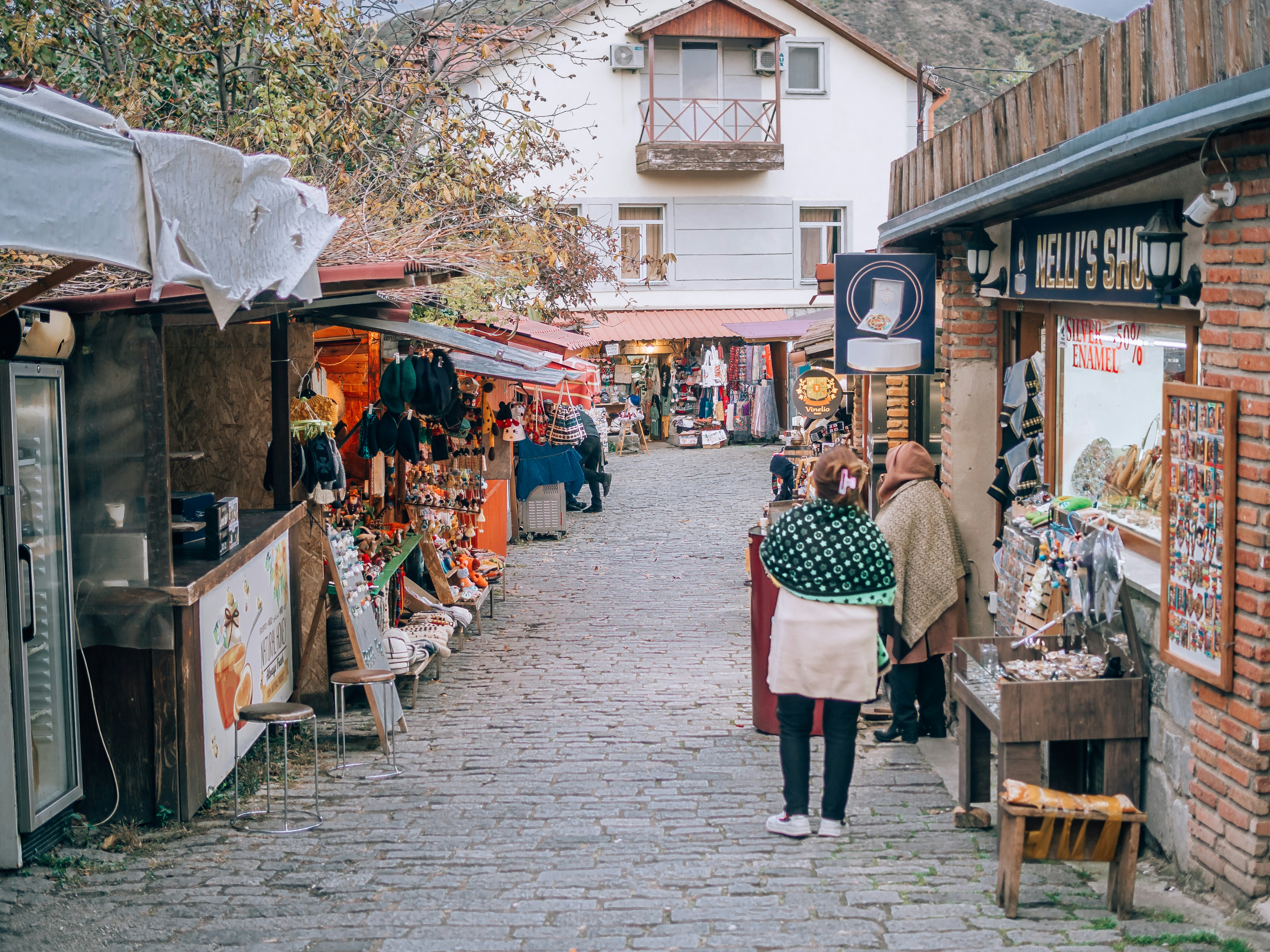 A man and woman walking down a street, 