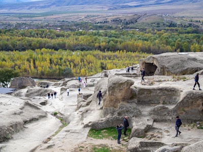 A group of people standing on top of a rock formation