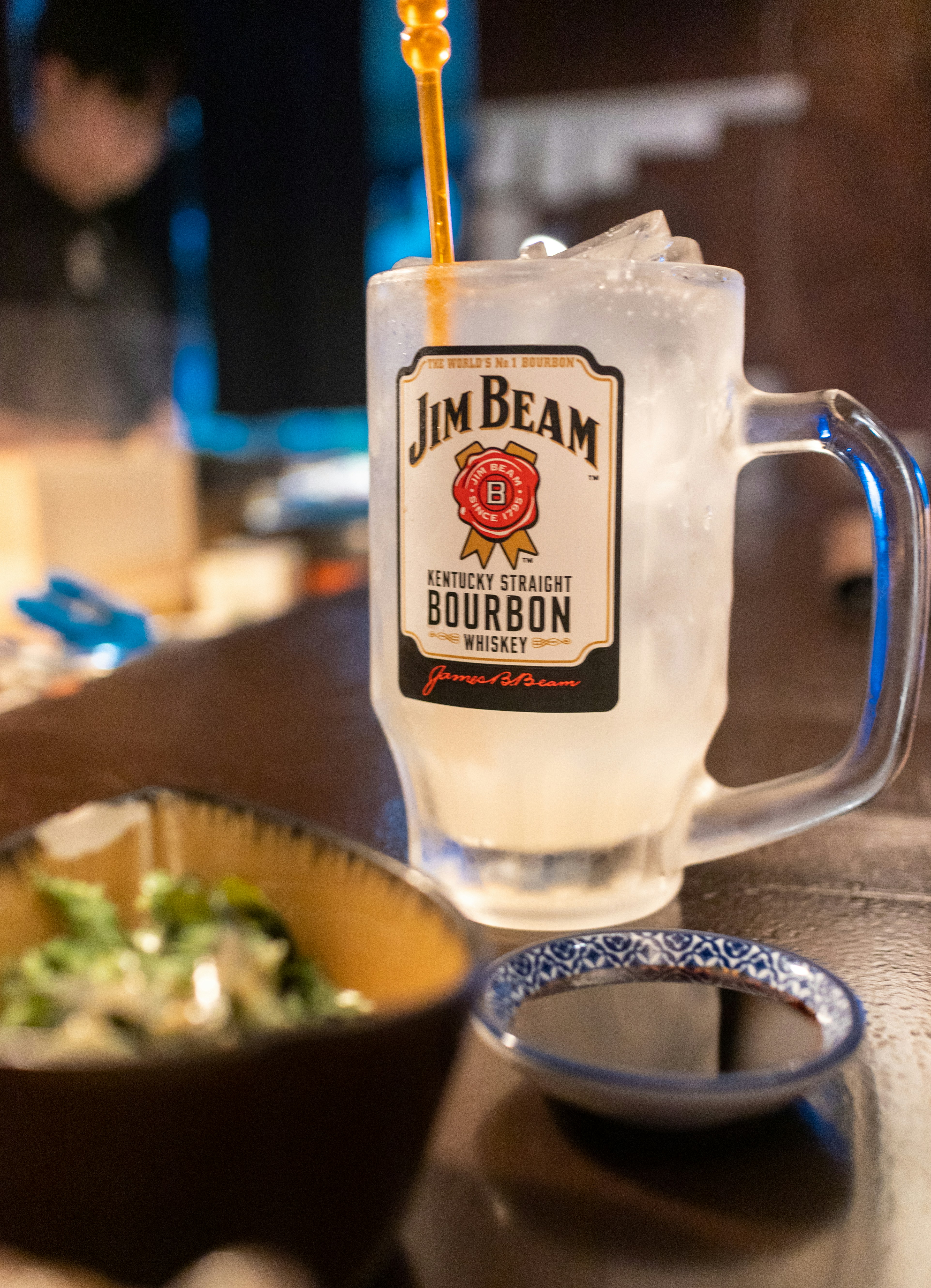 A drink being poured into a glass