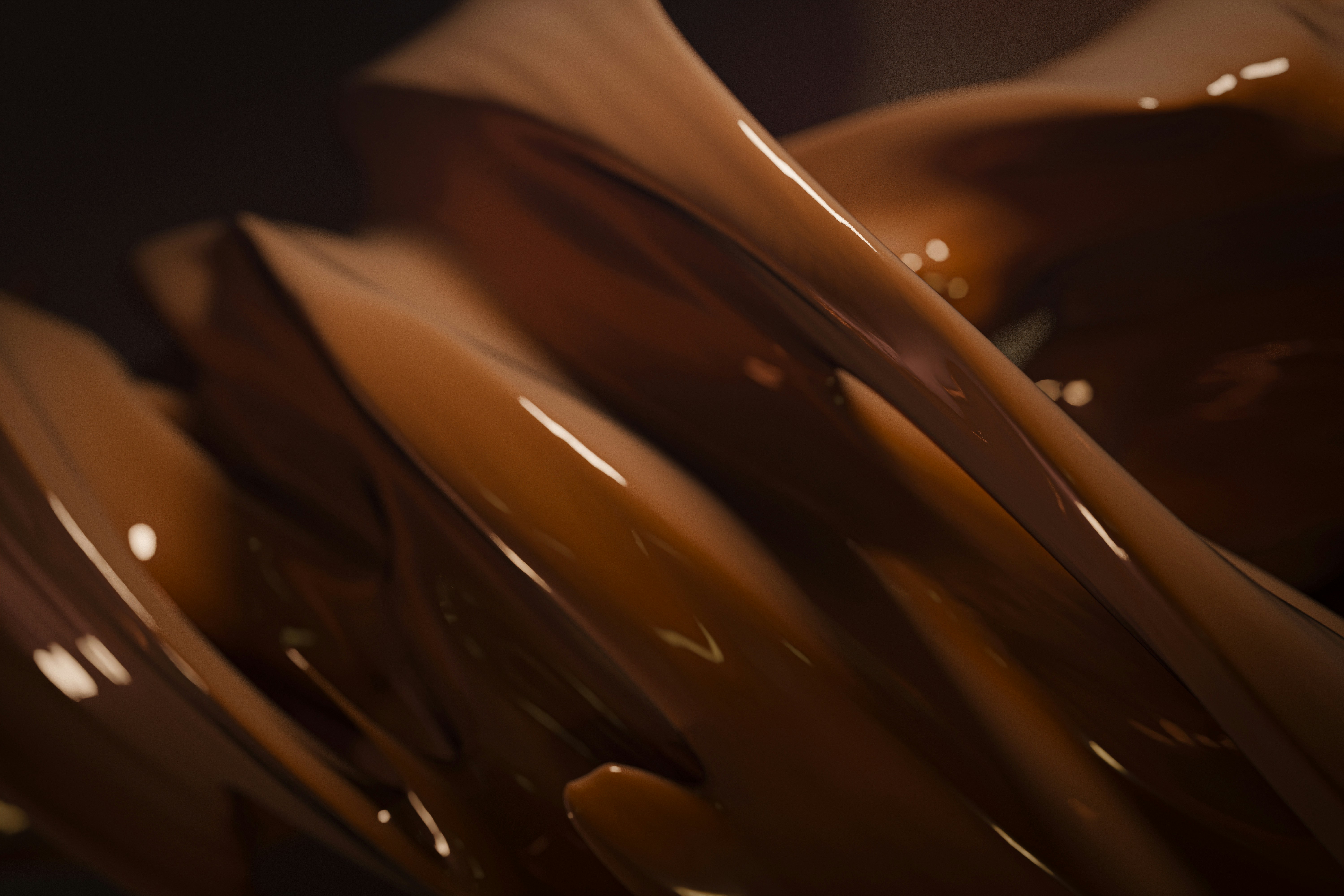 A close up view of chocolate flowing in a bowl