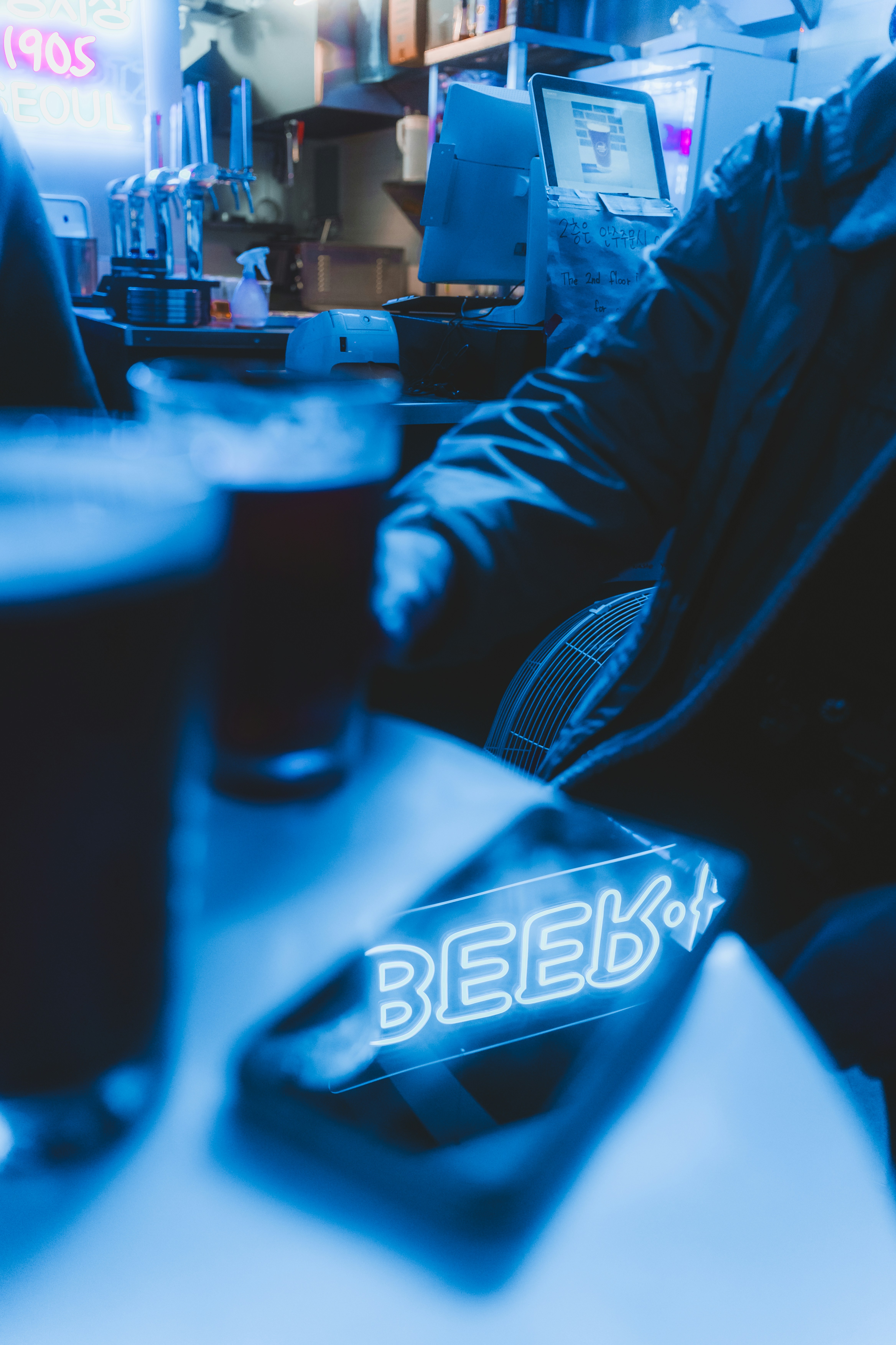 A man sitting at a table with a glass of beer