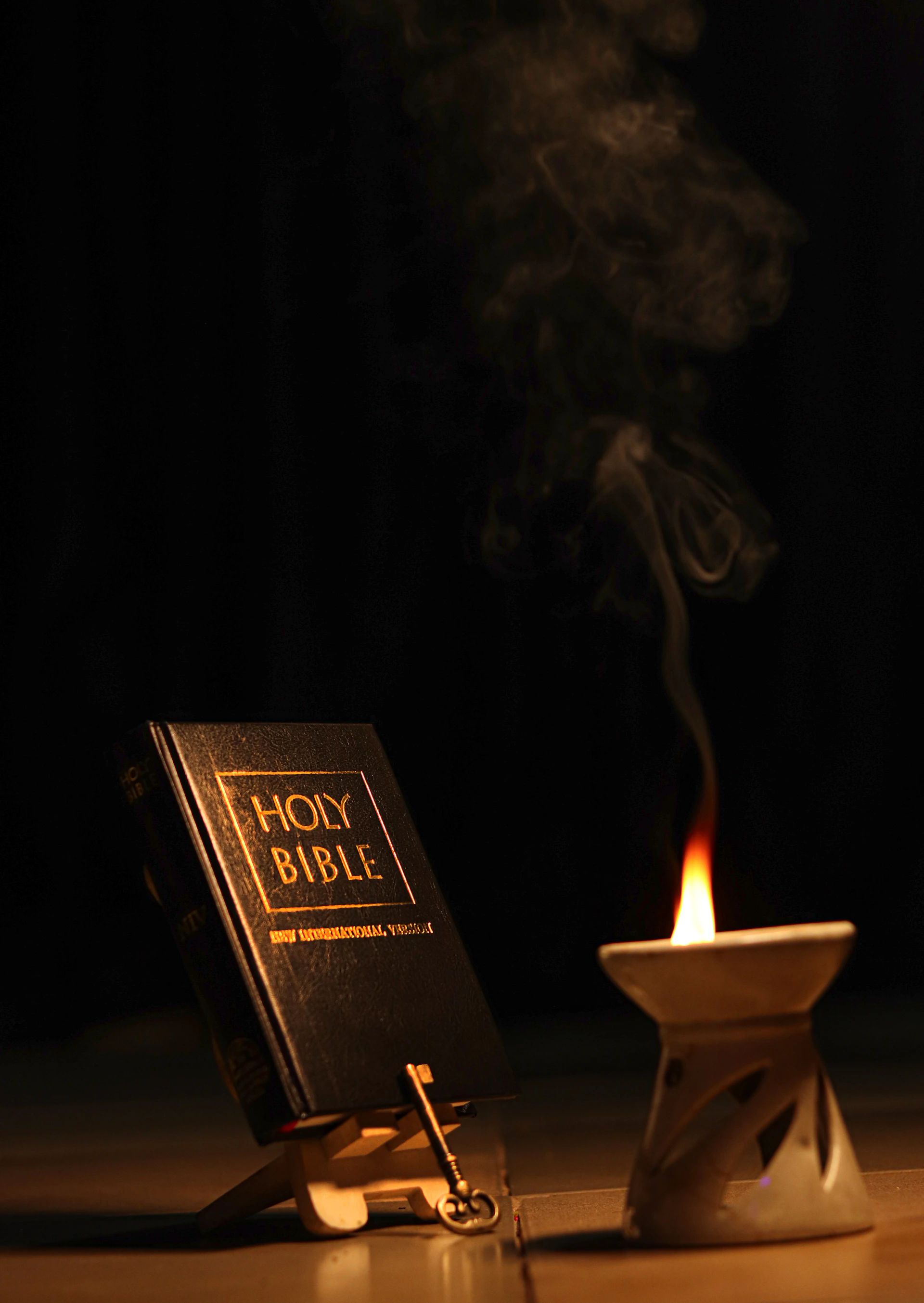 A candle and a book on a table