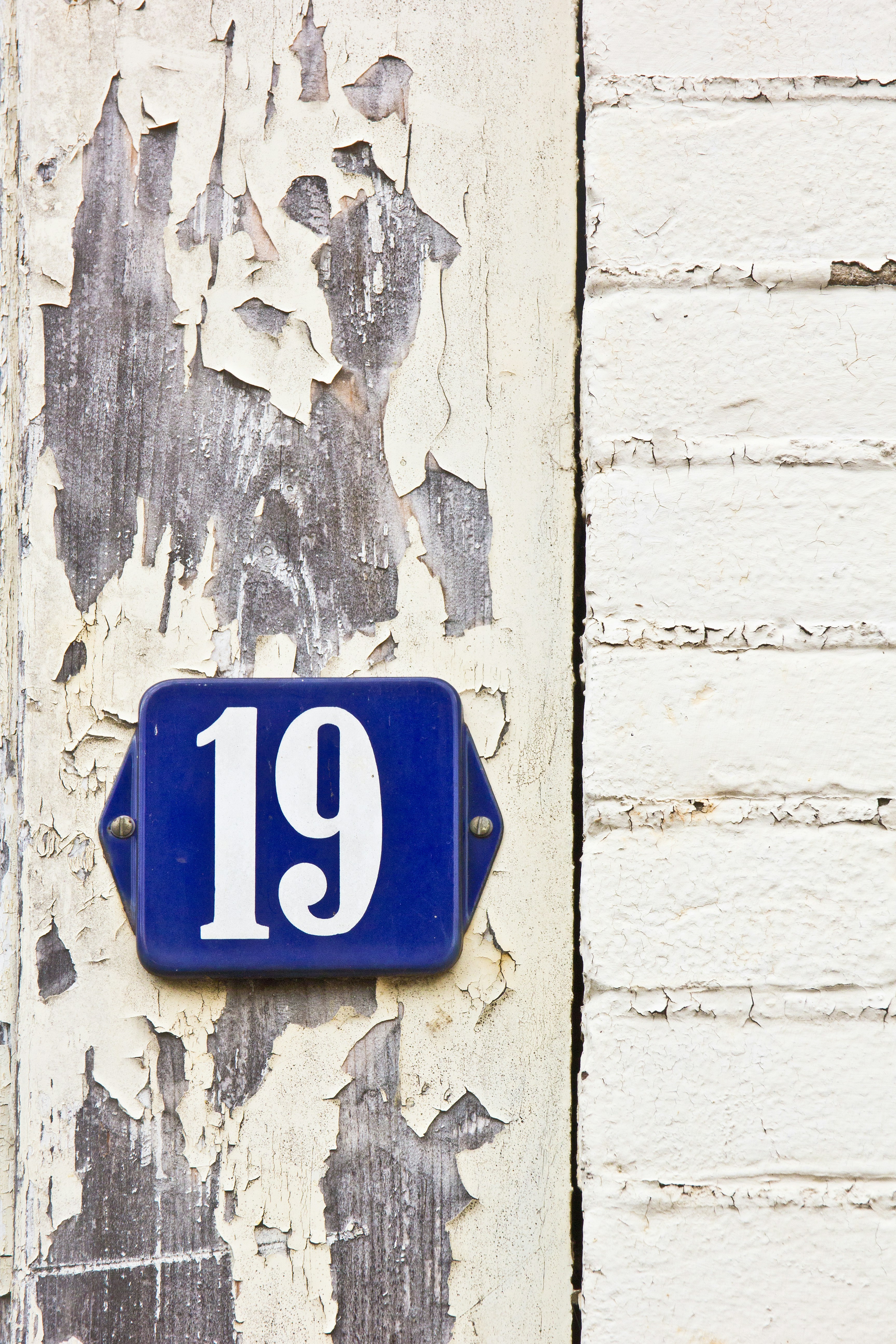 A close up of a blue sign on a building photo – Free Woman Image on ...