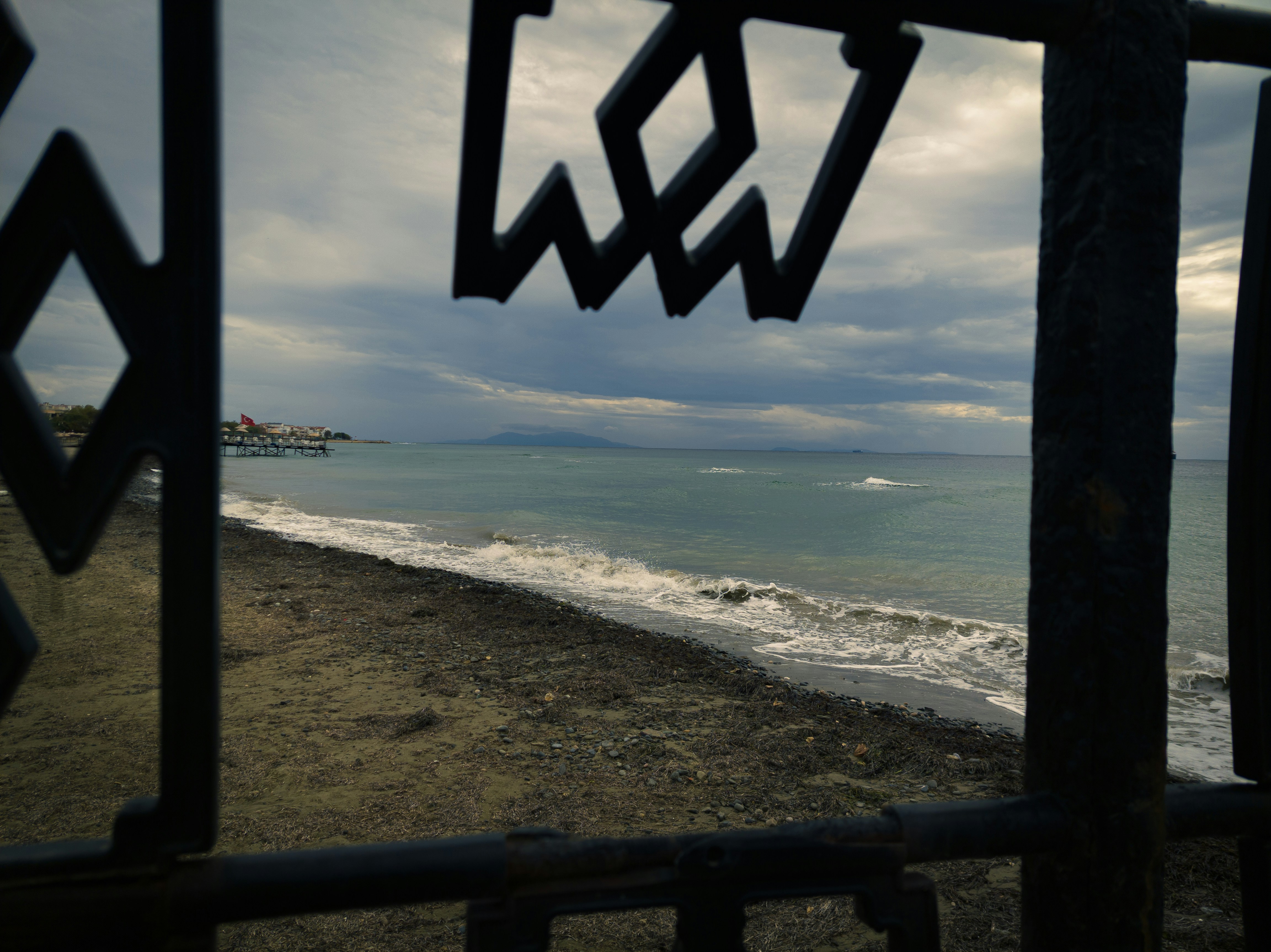 A view of a beach through a gate