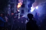 A crowd of people standing around a fire hydrant