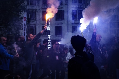 A crowd of people standing around a fire hydrant