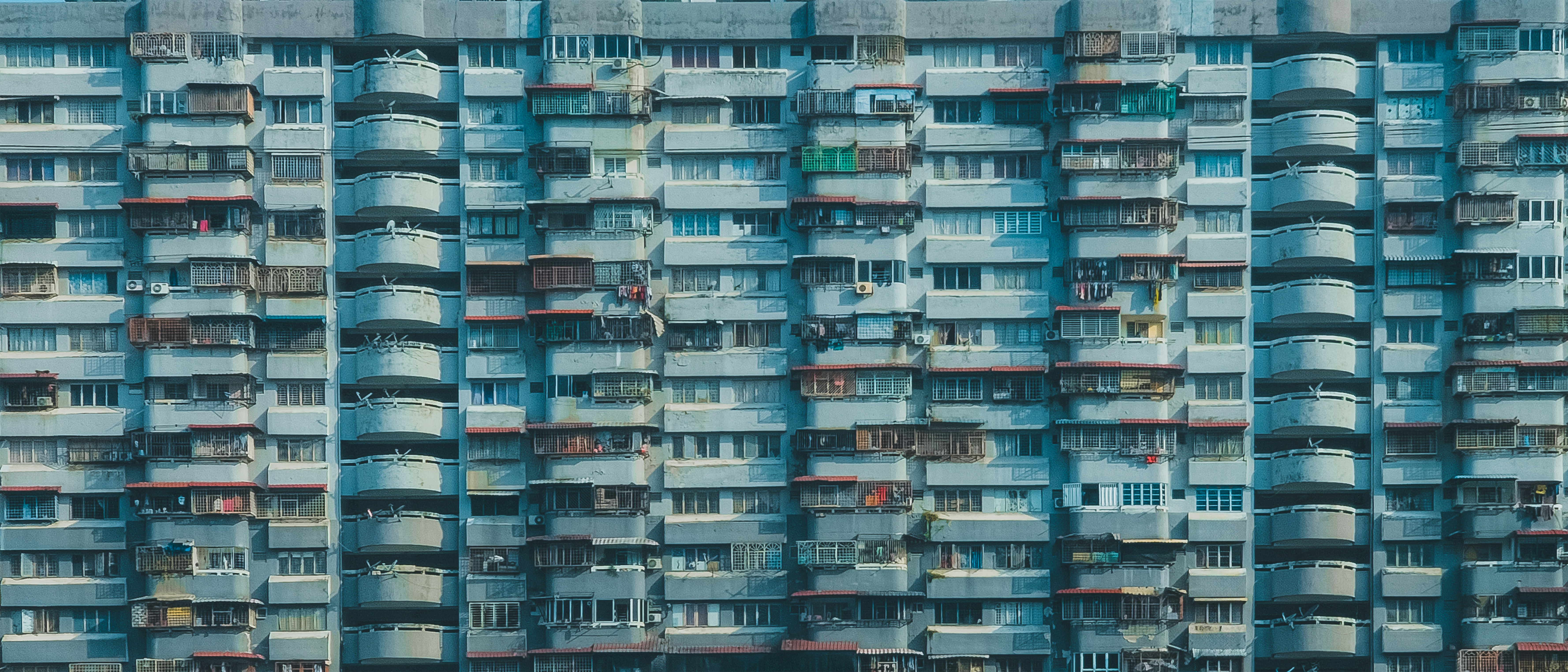 Modern compact home exterior with tall building and windows