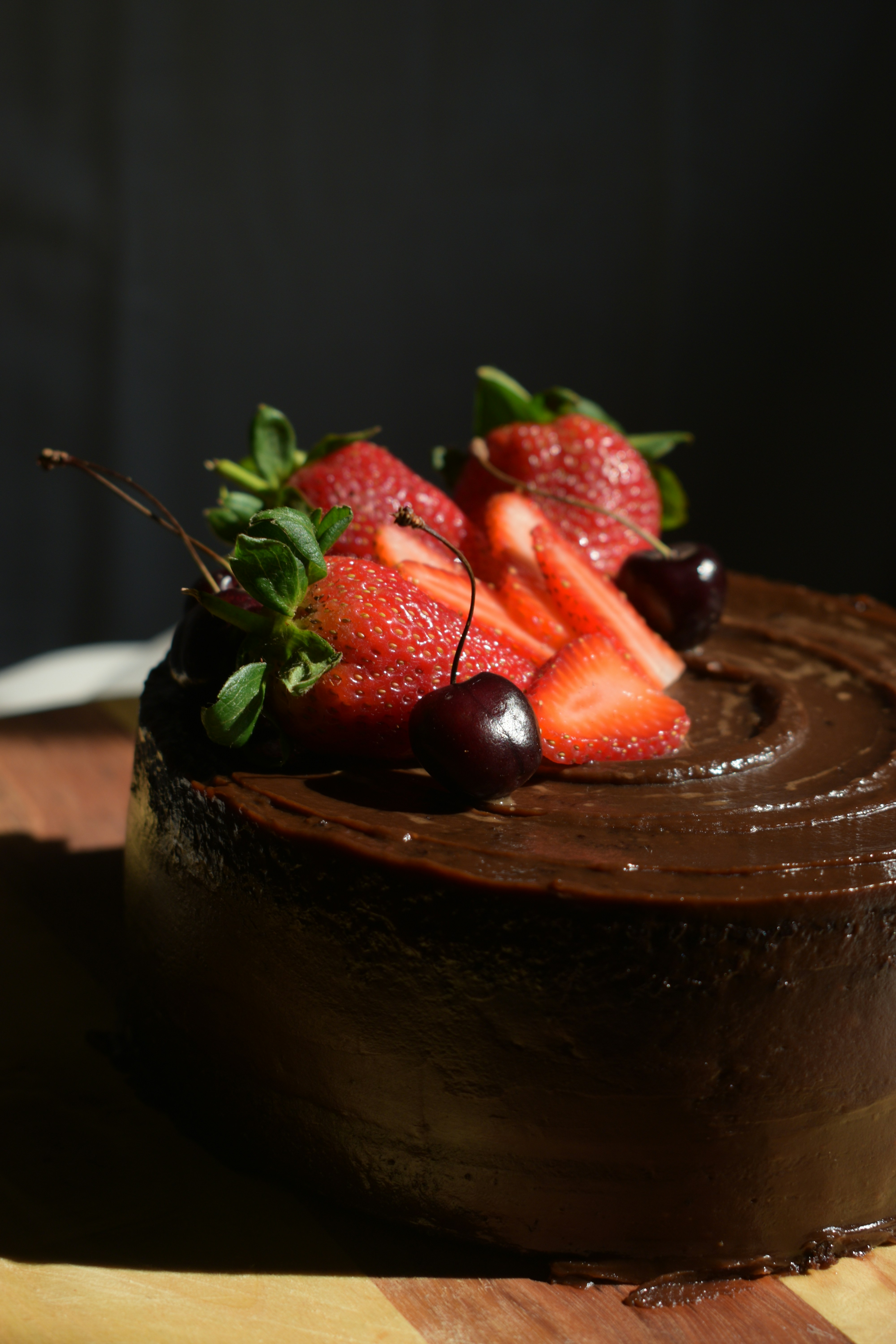 A chocolate cake with strawberries on top of it
