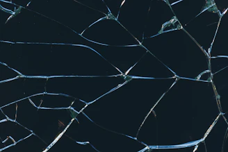 A close up of a broken glass window