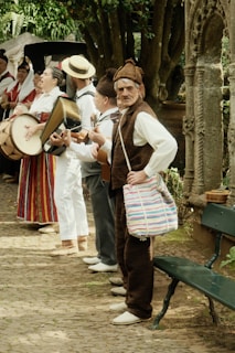 A group of people standing next to each other near a bench