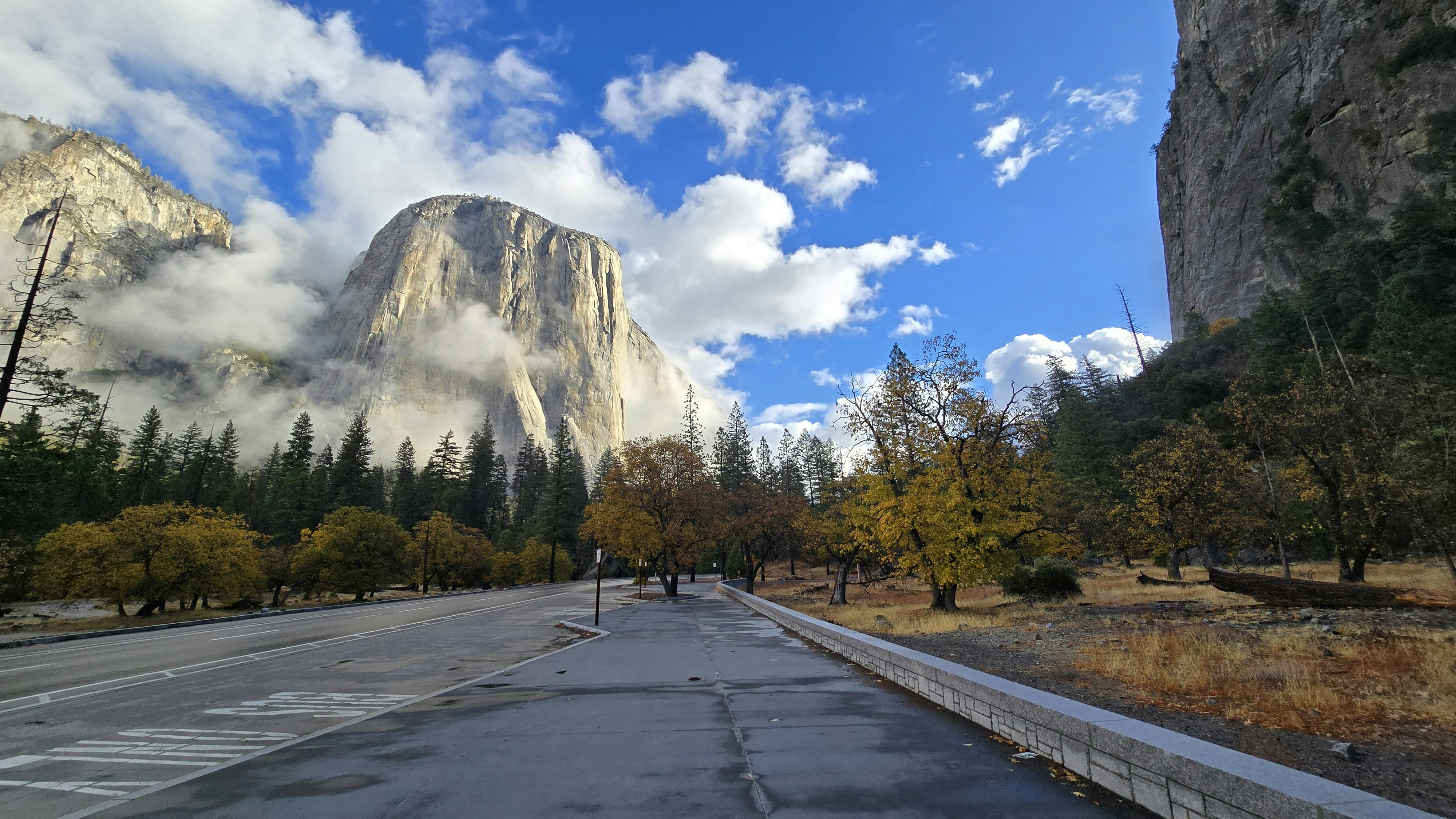 A wide shot of a road with a mountain in the background