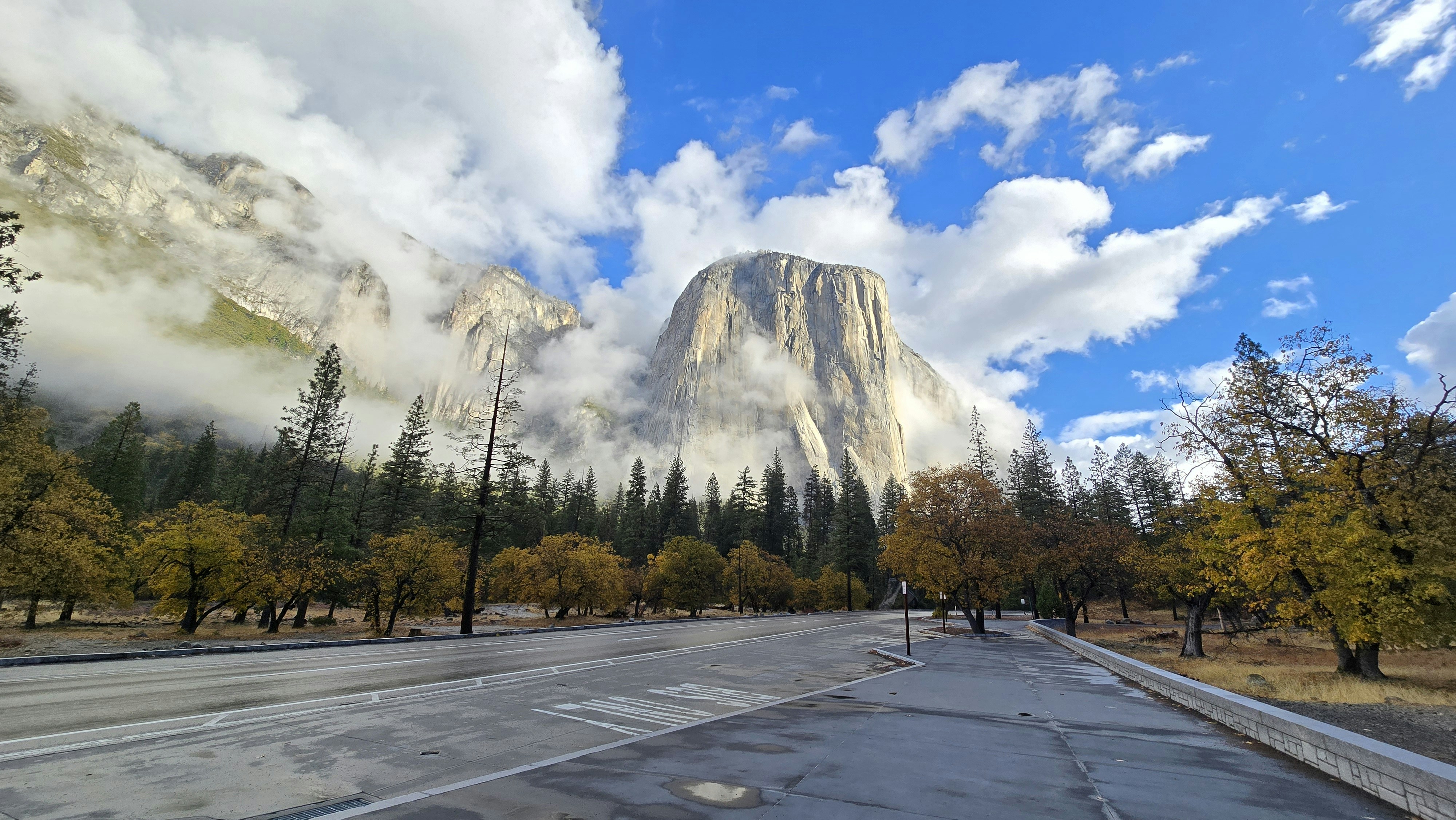 A picture of a road with a mountain in the background