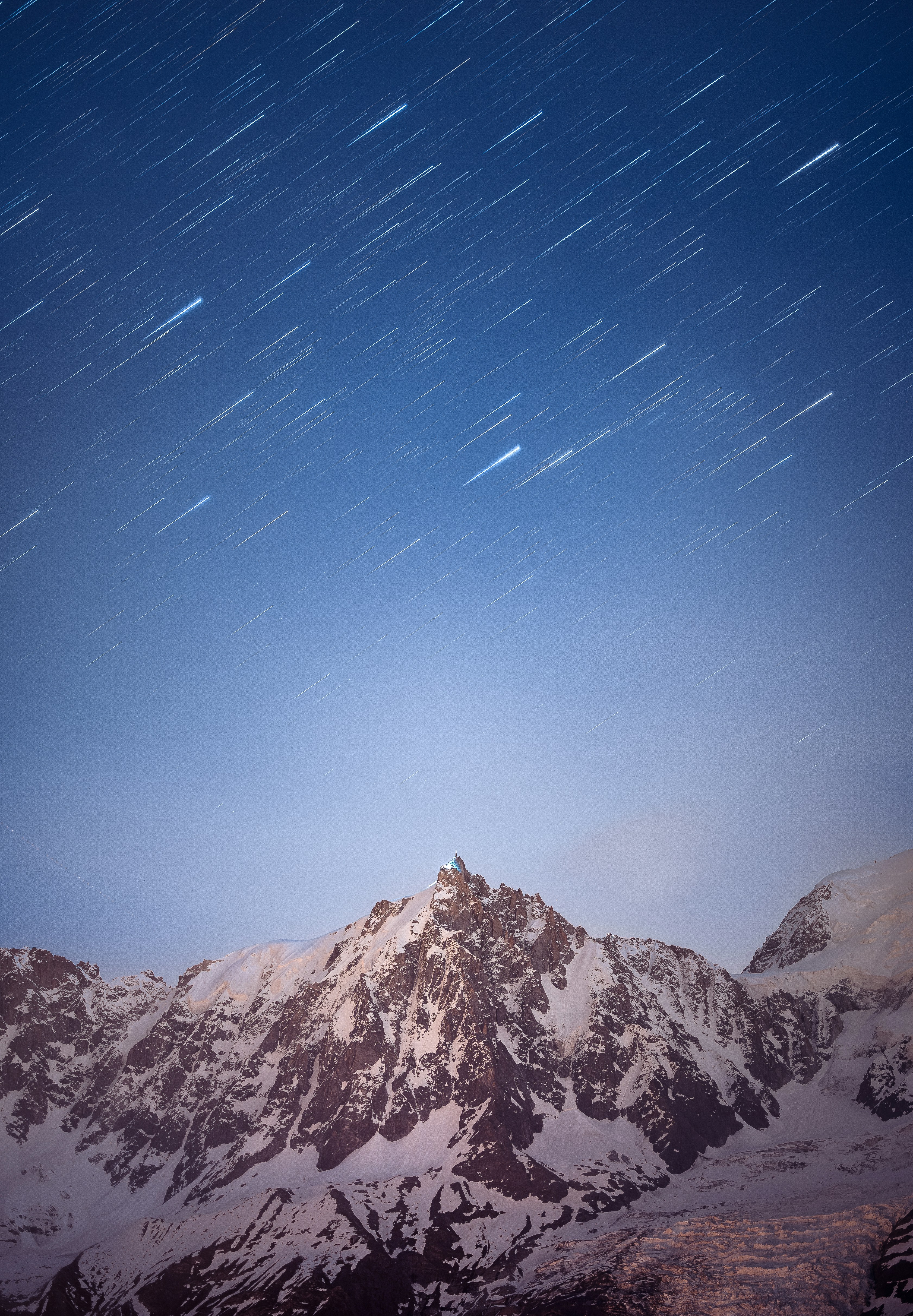 Una montaña cubierta de nieve bajo un cielo nocturno