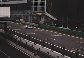 A car driving down a highway next to tall buildings